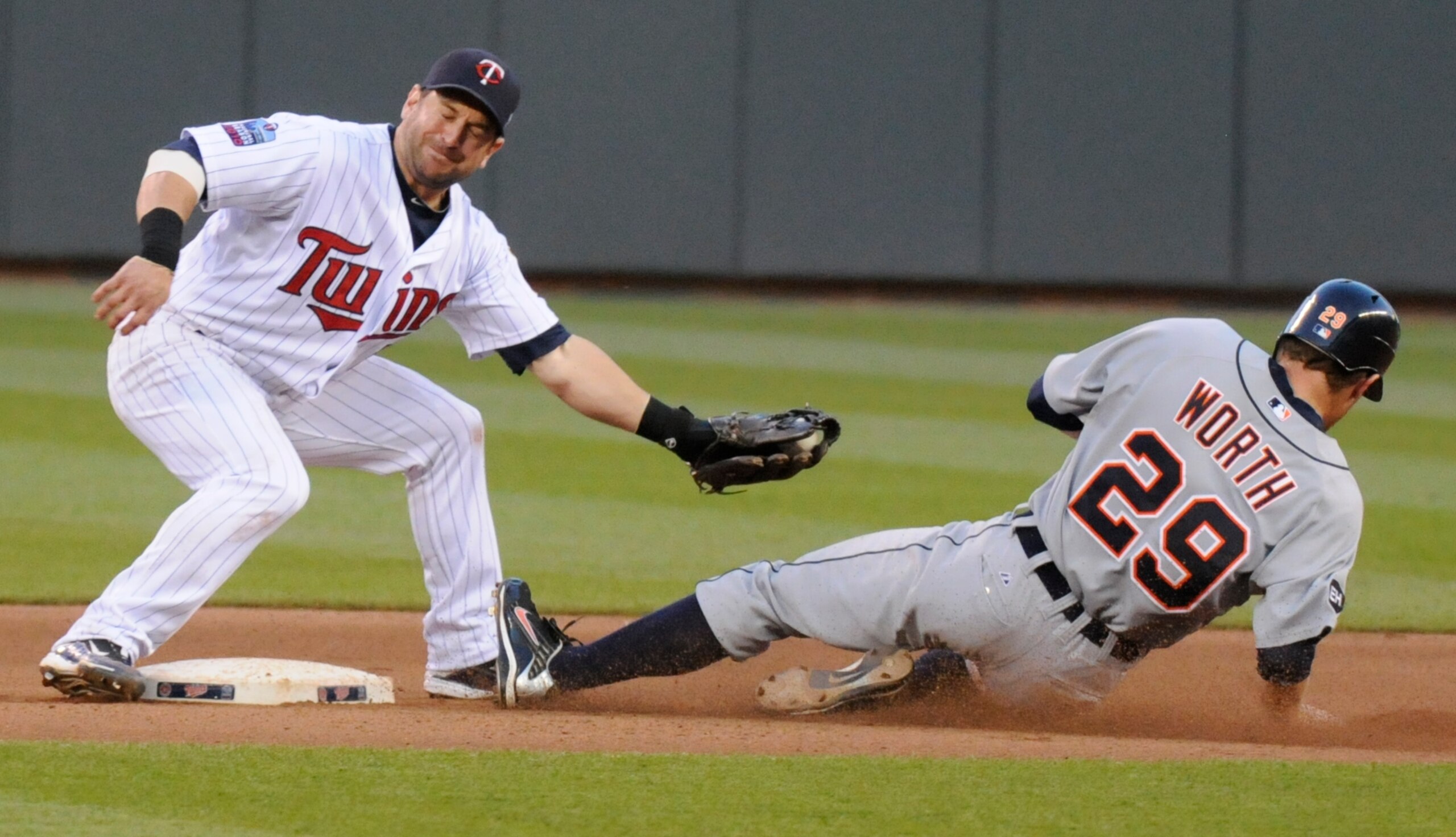 MINNEAPOLIS, MN - JUNE 28: Danny Worth #29 of the Detroit Tigers slides under the tag by Nick Punto #8 of the Minnesota Twins to steal second base in the fourth inning during their game on June 28, 2010 at Target Field in Minneapolis, Minnesota. Tigers de