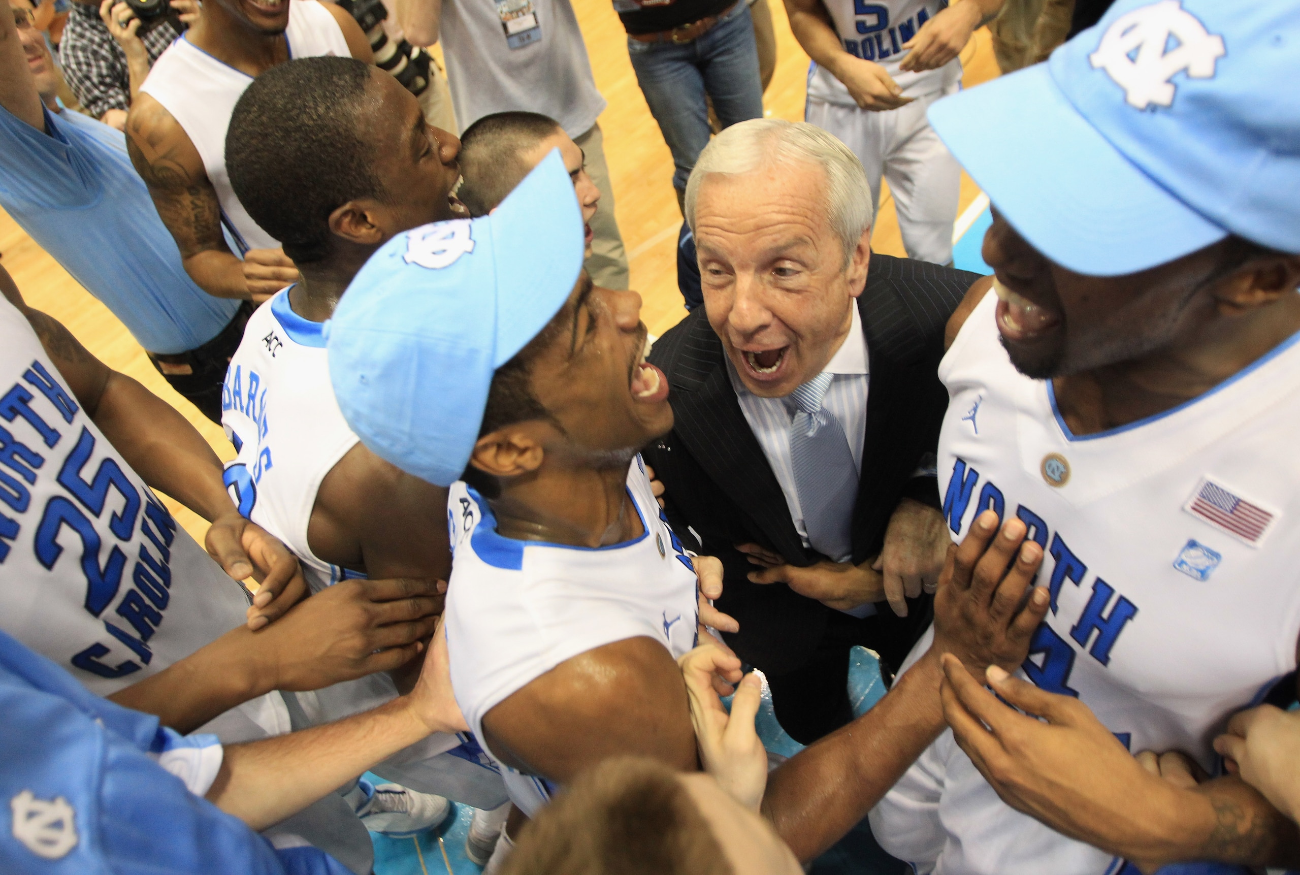 CHAPEL HILL, NC - MARCH 05:  Head coach Roy Williams of the North Carolina Tar Heels celebrates winning the ACC Regular Season Championship with his players as they defeated the Duke Blue Devils 81-67 at the Dean E. Smith Center on March 5, 2011 in Chapel
