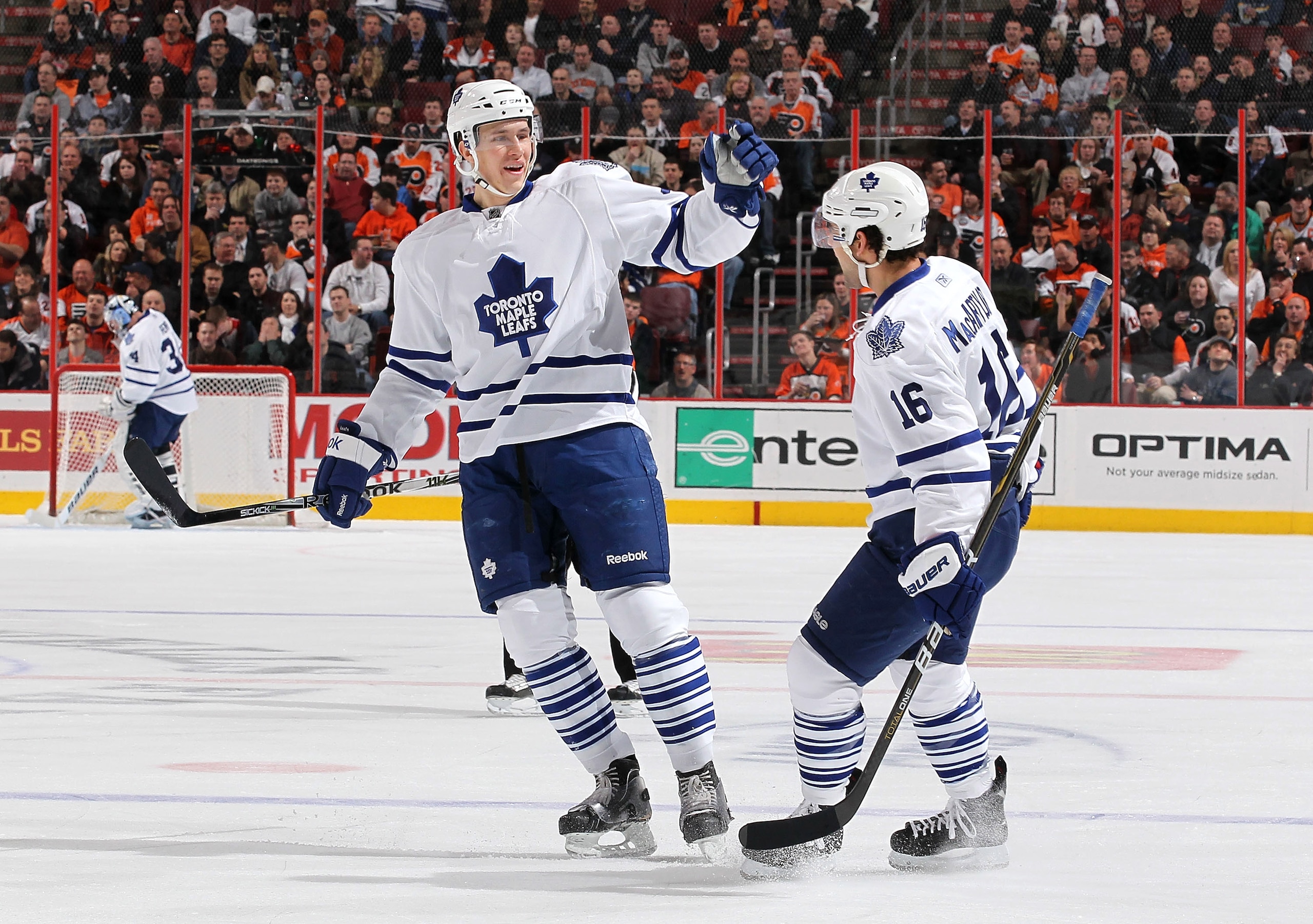 PHILADELPHIA - MARCH 03:  Keith Aulie #59 of the Toronto Maple Leafs celebrates a goal by Clarke MacArthur #16 of The Philadelphia Flyers during their game on March 3, 2011 at The Wells Fargo Center in Philadelphia, Pennsylvania.  (Photo by Al Bello/Getty