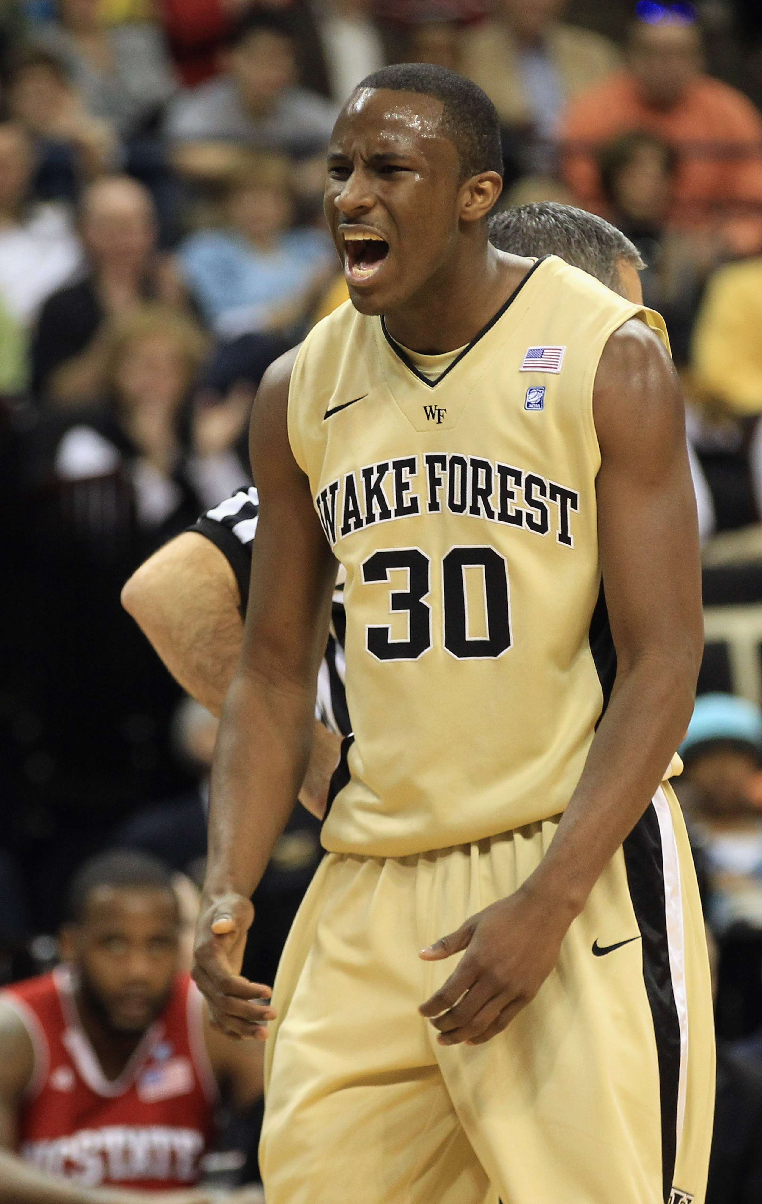 WINSTON SALEM, NC - FEBRUARY 13:  Travis McKie #30 of the Wake Forest Demon Deacons reacts to a play during their game against the North Carolina State Wolfpack at Lawrence Joel Coliseum on February 13, 2011 in Winston Salem, North Carolina.  (Photo by St