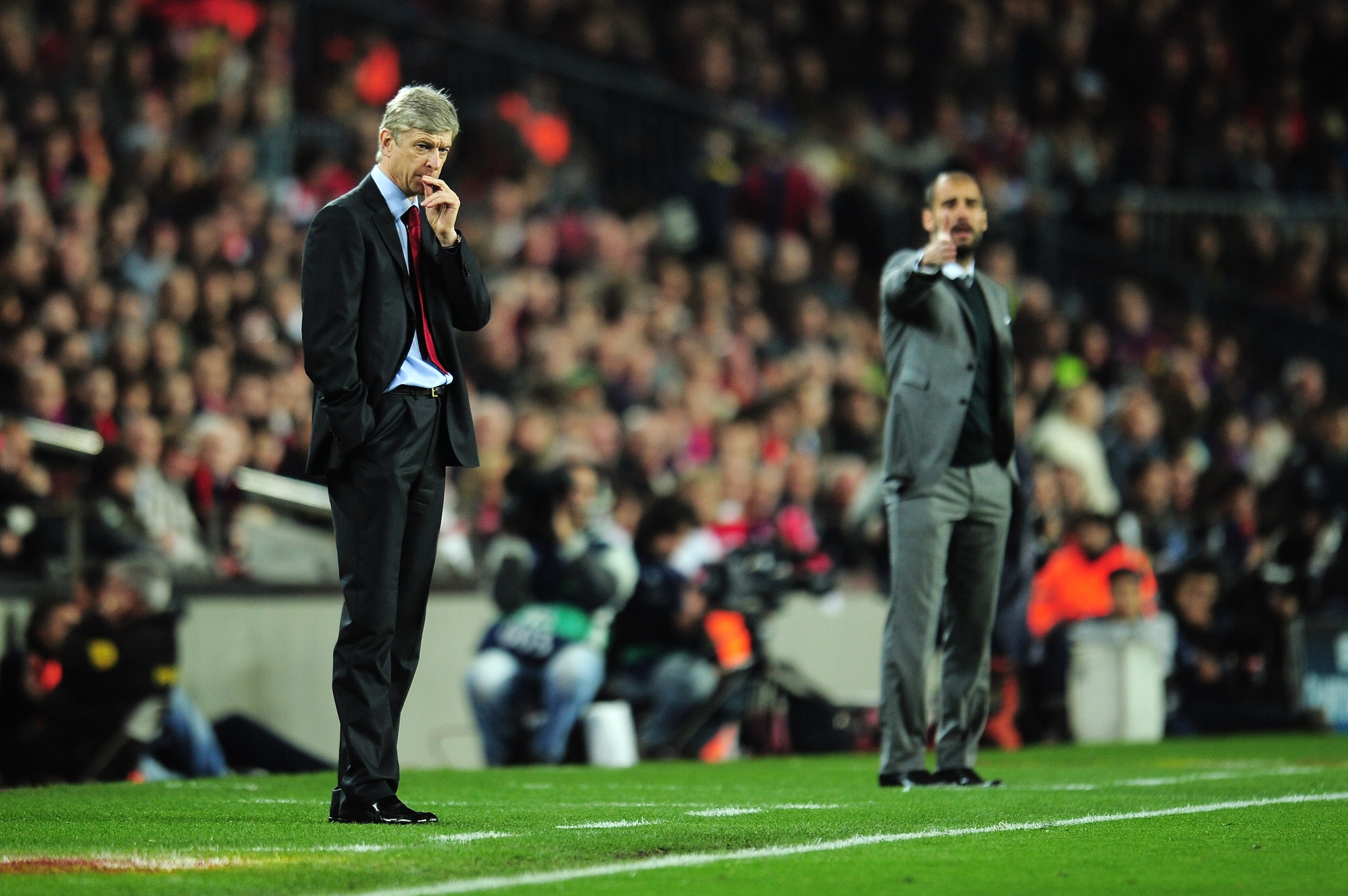 BARCELONA, SPAIN - APRIL 06:  Manager of Arsenal Arsene Wenger and manager of Barcelona Josep Guardiola react on the touchline during the UEFA Champions League quarter final second leg match between Barcelona and Arsenal at Camp Nou on April 6, 2010 in Ba