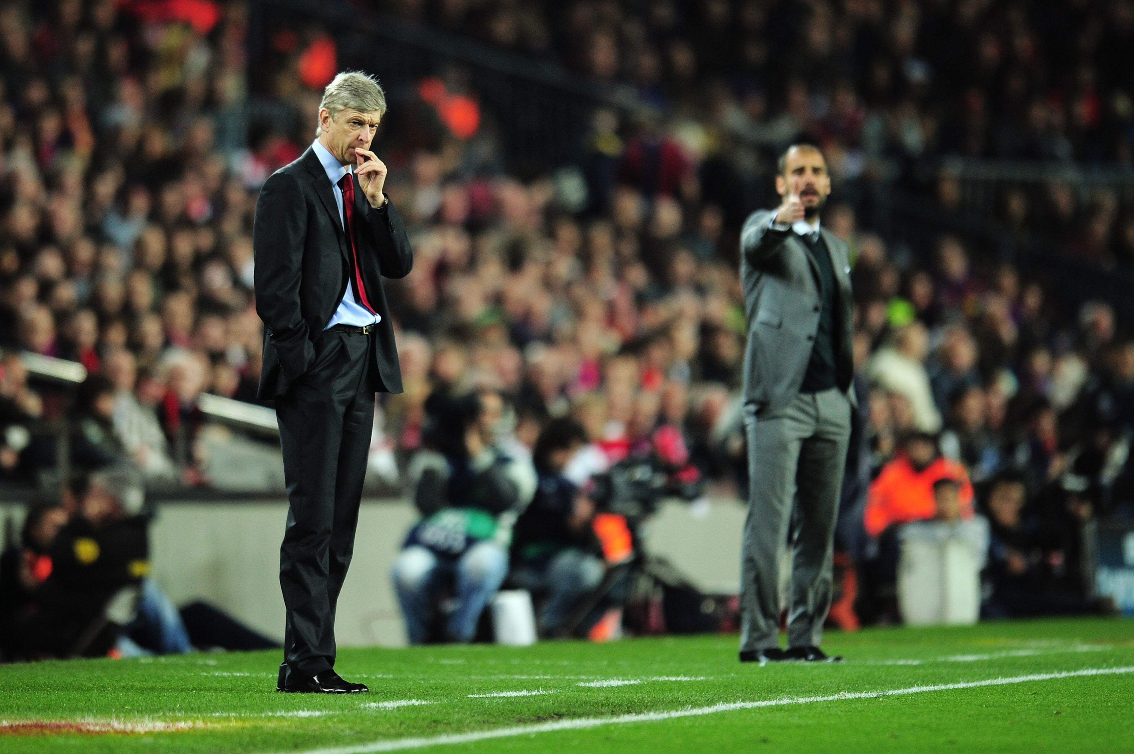 BARCELONA, SPAIN - APRIL 06:  Manager of Arsenal Arsene Wenger and manager of Barcelona Josep Guardiola react on the touchline during the UEFA Champions League quarter final second leg match between Barcelona and Arsenal at Camp Nou on April 6, 2010 in Ba