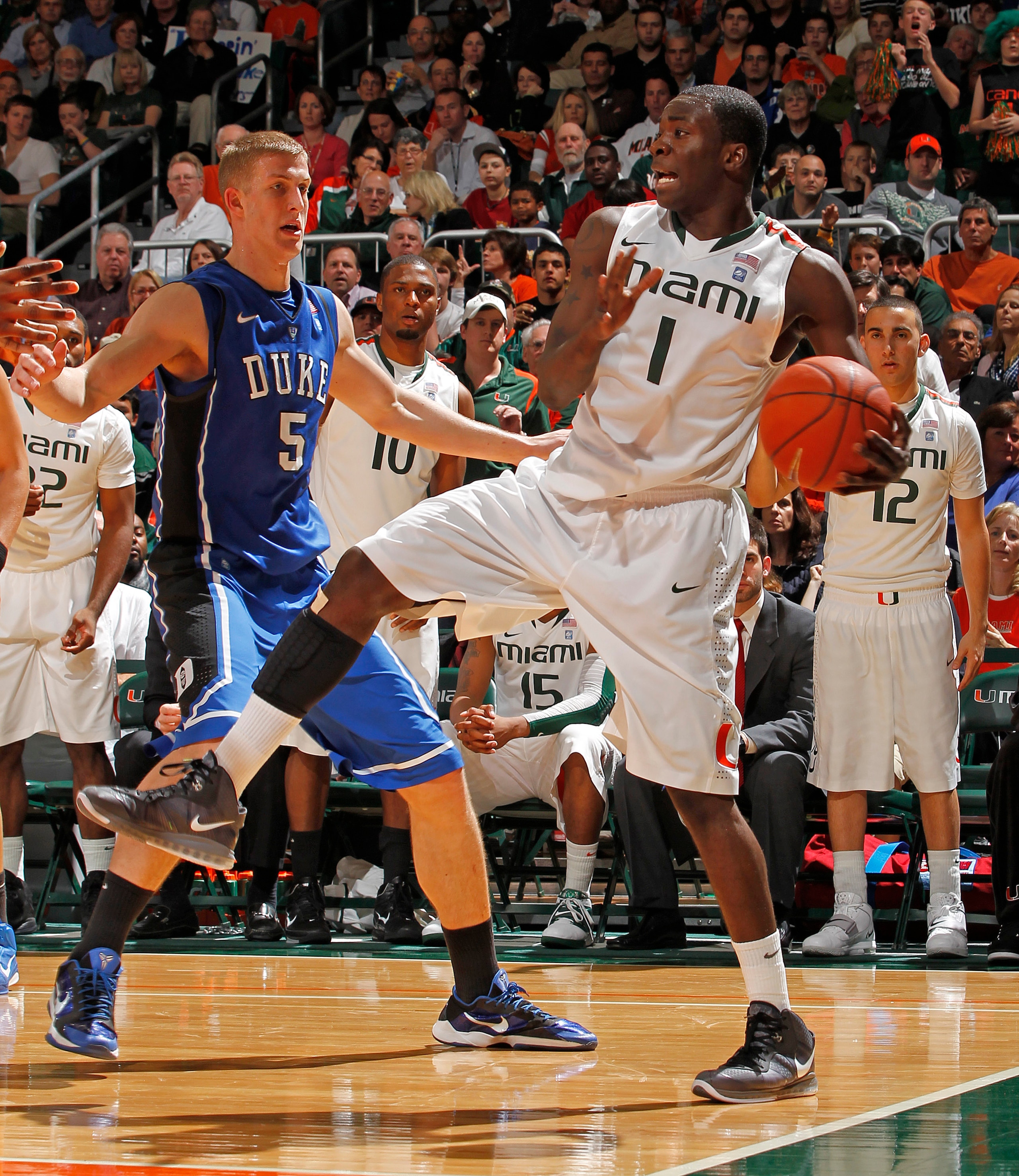 CORAL GABLES, FL - FEBRUARY 13: Mason Plumlee #5 of the Duke Blue Devils defends against Durand Scott #1 of the Miami Hurricanes on February 13, 2011 at the BankUnited Center in Coral Gables, Florida. (Photo by Joel Auerbach/Getty Images)