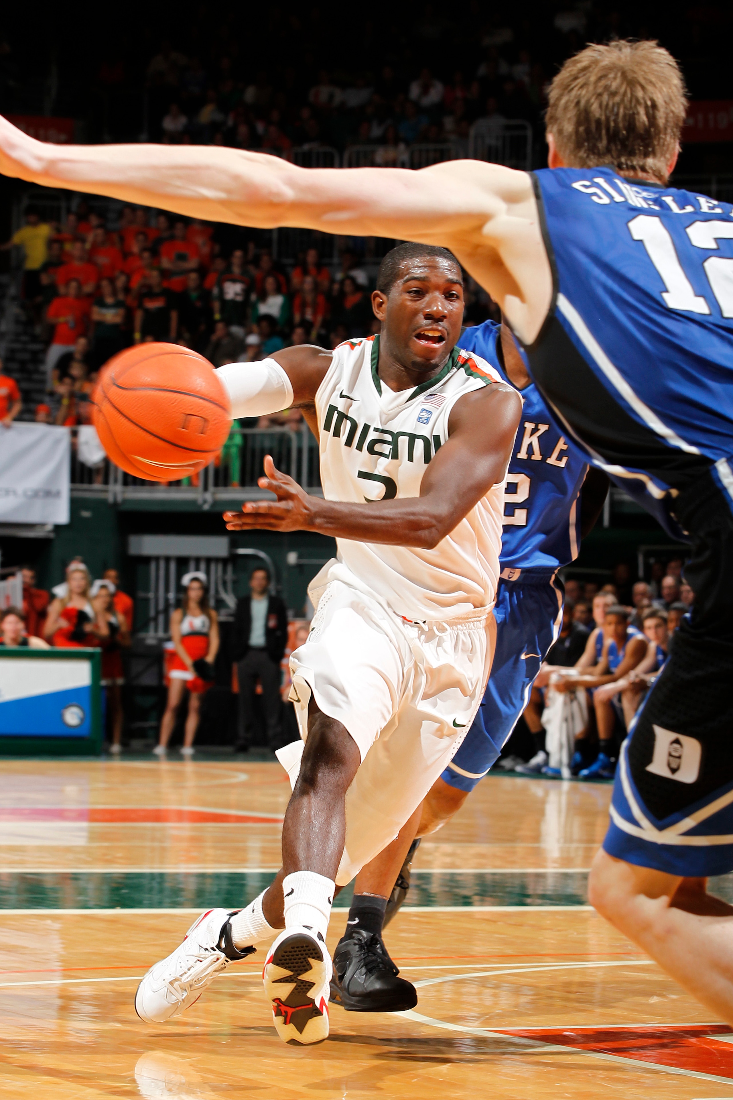 CORAL GABLES, FL - FEBRUARY 13: Malcolm Grant #3 of the Miami Hurricanes drives to the basket against Kyle Singler #12 of the Duke Blue Devils on February 13, 2011 at the BankUnited Center in Coral Gables, Florida. (Photo by Joel Auerbach/Getty Images)