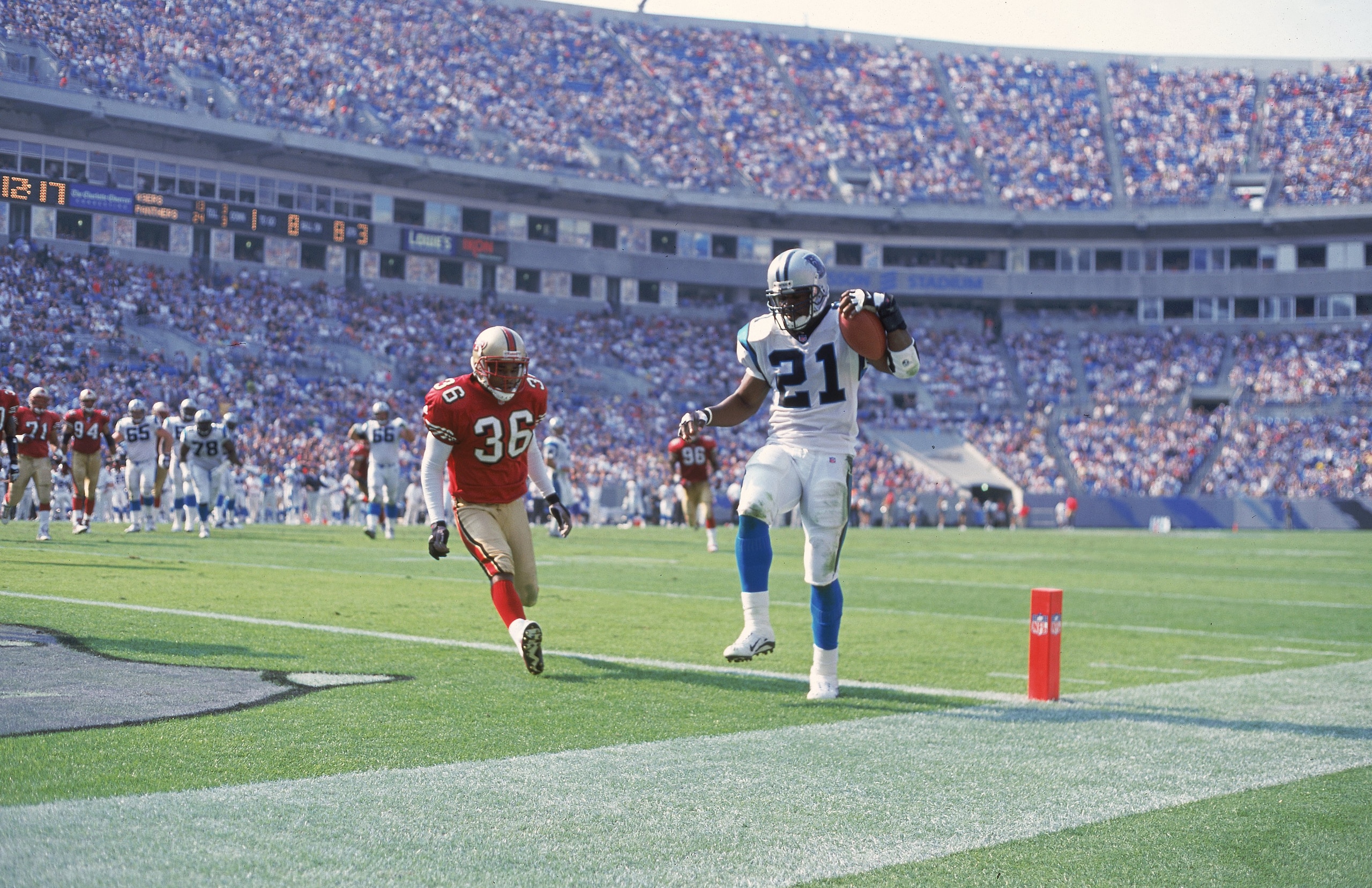 22 Oct 2000:  Tshimanga Biakabutaka #21 of the Carolina Panthers makes a touchdown as Jason Webster #36 of the San Francisco 49ers runs next to him during the game at the Ericsson Stadium in Charlotte, North Carolina. The Panthers defeated the 49ers 34-16