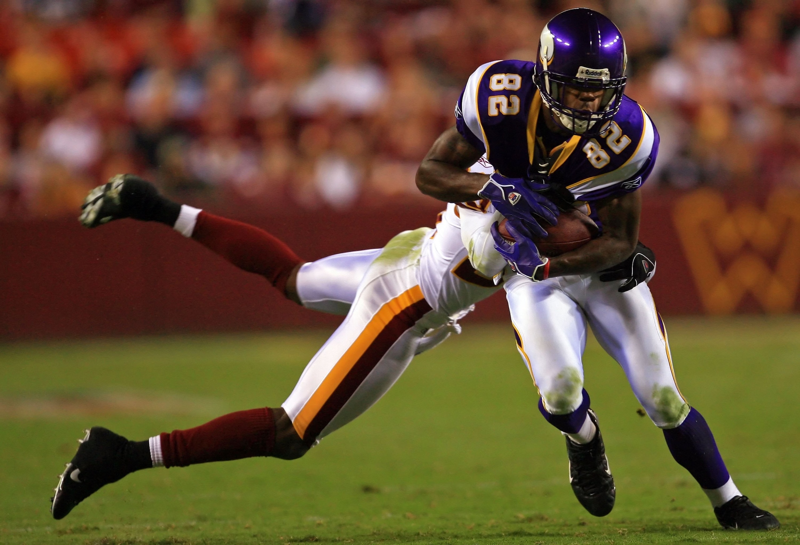 LANDOVER, MD - SEPTEMBER 11:  Troy Williamson #82 of the Minnesota Vikings is tackled by Mike Rumph #29 of Washington Redskins during the first Monday Night Football game of the season on September 11, 2006 at FedEx Field in Landover, Maryland.  (Photo by