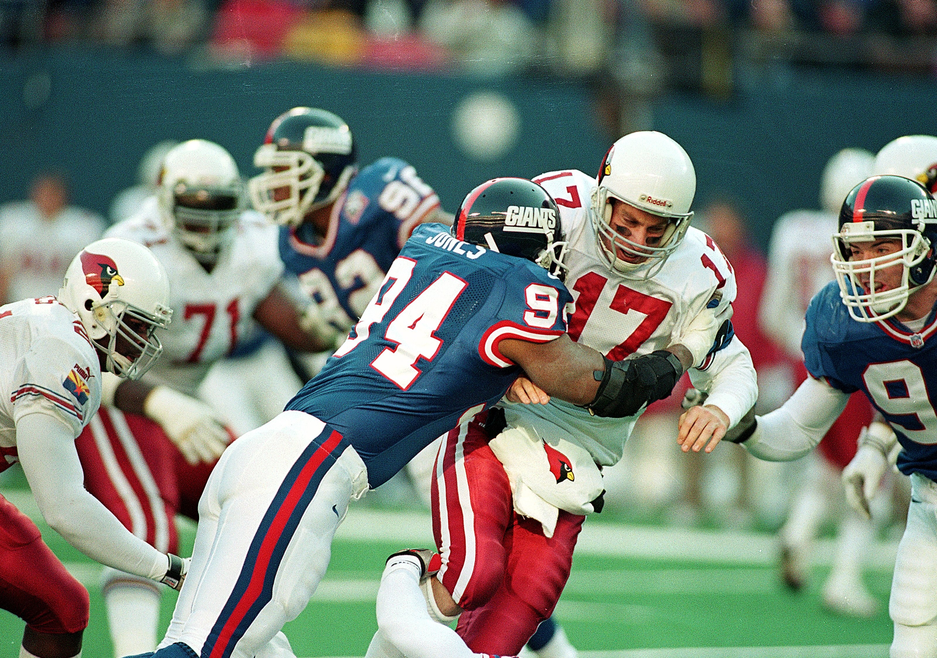 28 Nov 1999:  Cedric Jones #94 of the New York Giants hits Dave Brown #17 of the Arizona Cardinals during the game at the Giants Stadium in East Rutherford, New Jersey. The Cardinals defeated the Giants 34-24. Mandatory Credit: Al Bello  /Allsport
