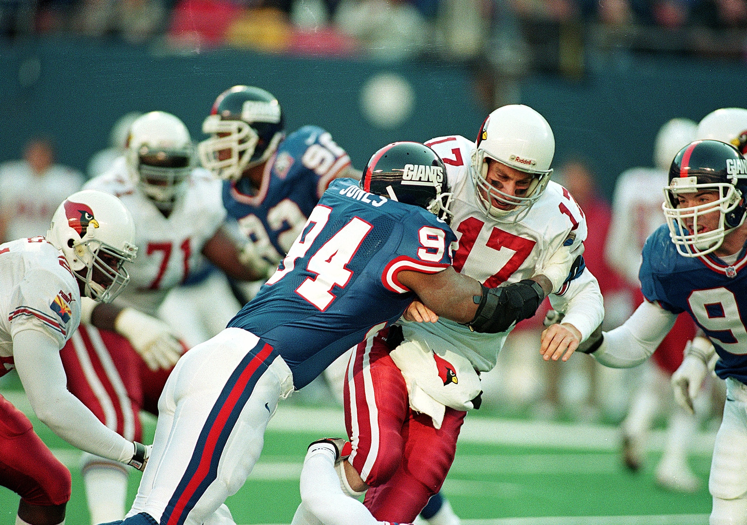 28 Nov 1999:  Cedric Jones #94 of the New York Giants hits Dave Brown #17 of the Arizona Cardinals during the game at the Giants Stadium in East Rutherford, New Jersey. The Cardinals defeated the Giants 34-24. Mandatory Credit: Al Bello  /Allsport