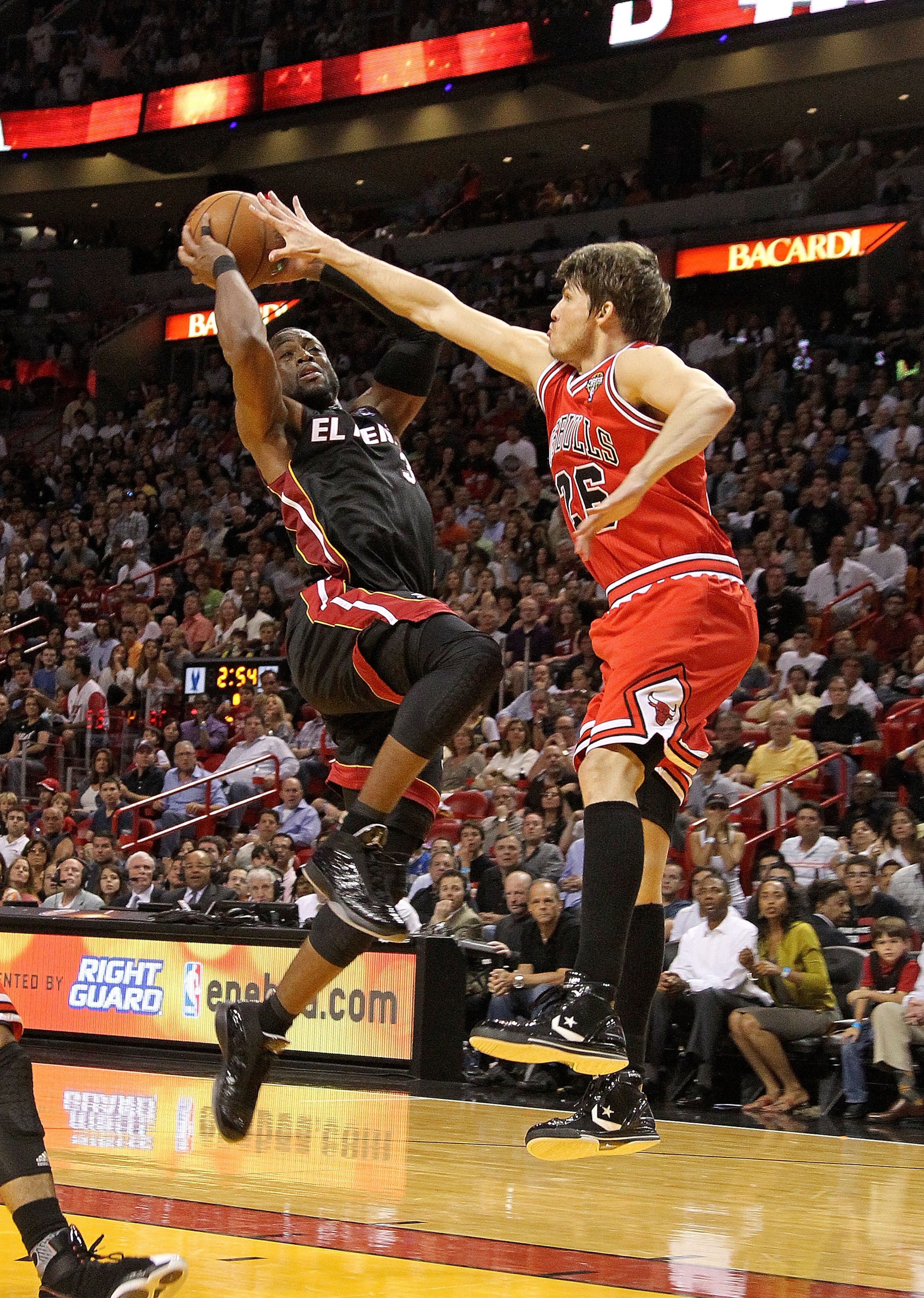 MIAMI, FL - MARCH 06:  Dwyane Wade #3 of the Miami Heat shoots over Kyle Korver #26 of the Chicago Bulls during a game at American Airlines Arena on March 6, 2011 in Miami, Florida. NOTE TO USER: User expressly acknowledges and agrees that, by downloading
