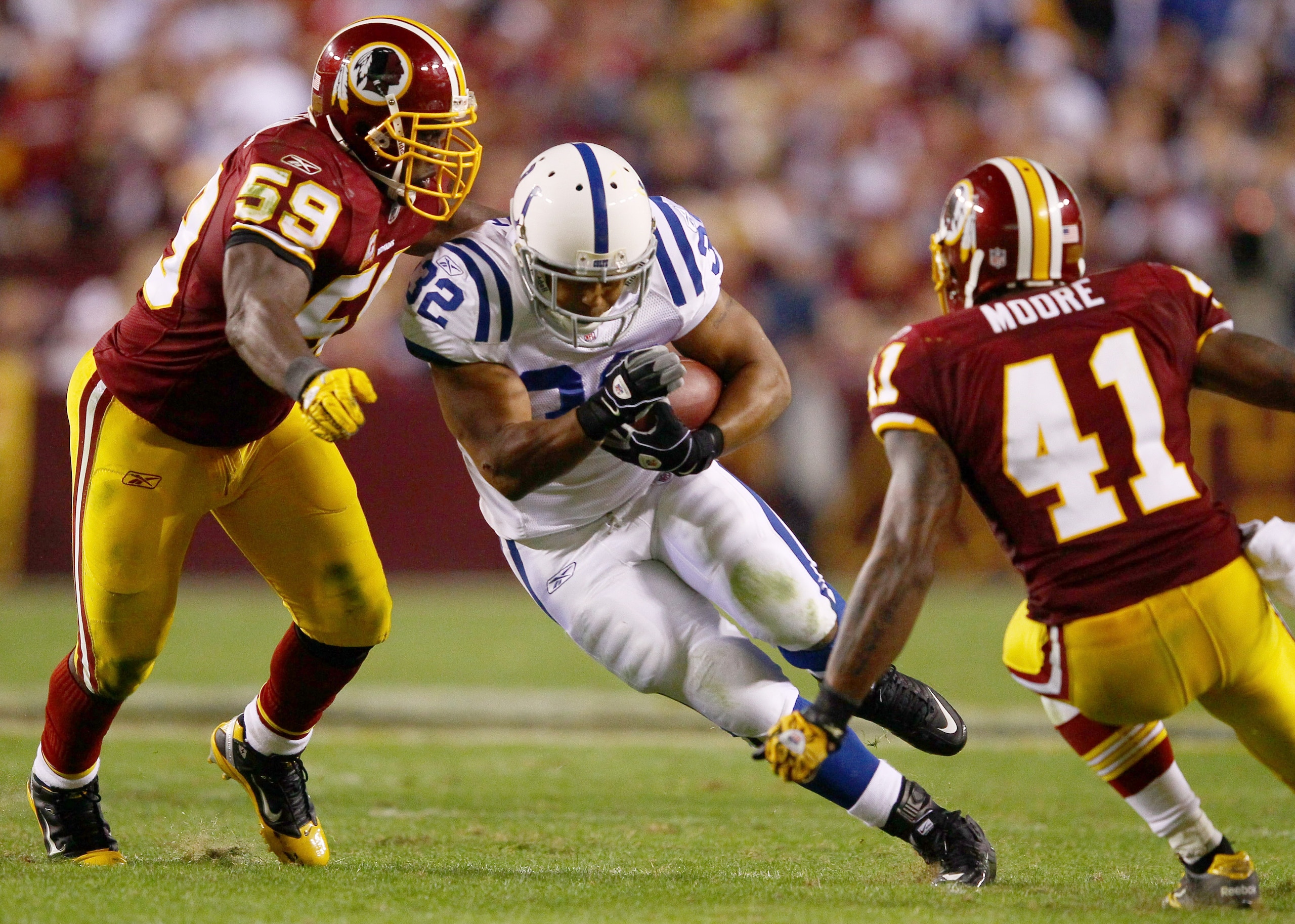 LANDOVER, MD - OCTOBER 17:  Running back Mike Hart #32 of the Indianapolis Colts is tackled by London Fletcher #59 and Kareem Moore #41 of the Washington Redskin at FedExField on October 17, 2010 in Landover, Maryland. The Colts won the game 27-24.  (Phot