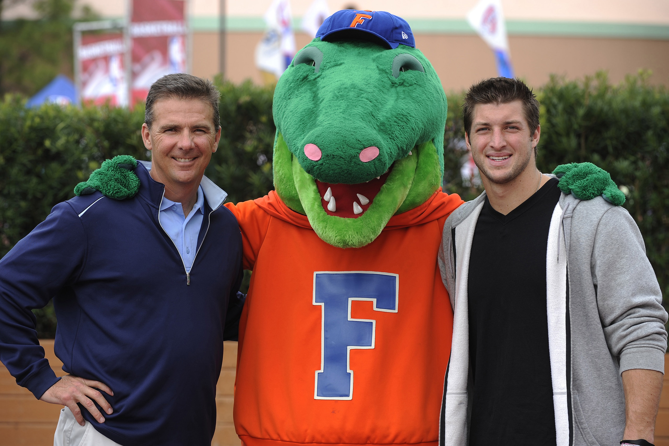 LAKE BUENA VISTA, FL - MARCH 05: (L-R) In this handout photo provided by Disney Parks, ESPN college football analyst and former University of Florida football coach, Urban Meyer, 'Albert' The University of Florida mascot and Denver Broncos Quarterback and