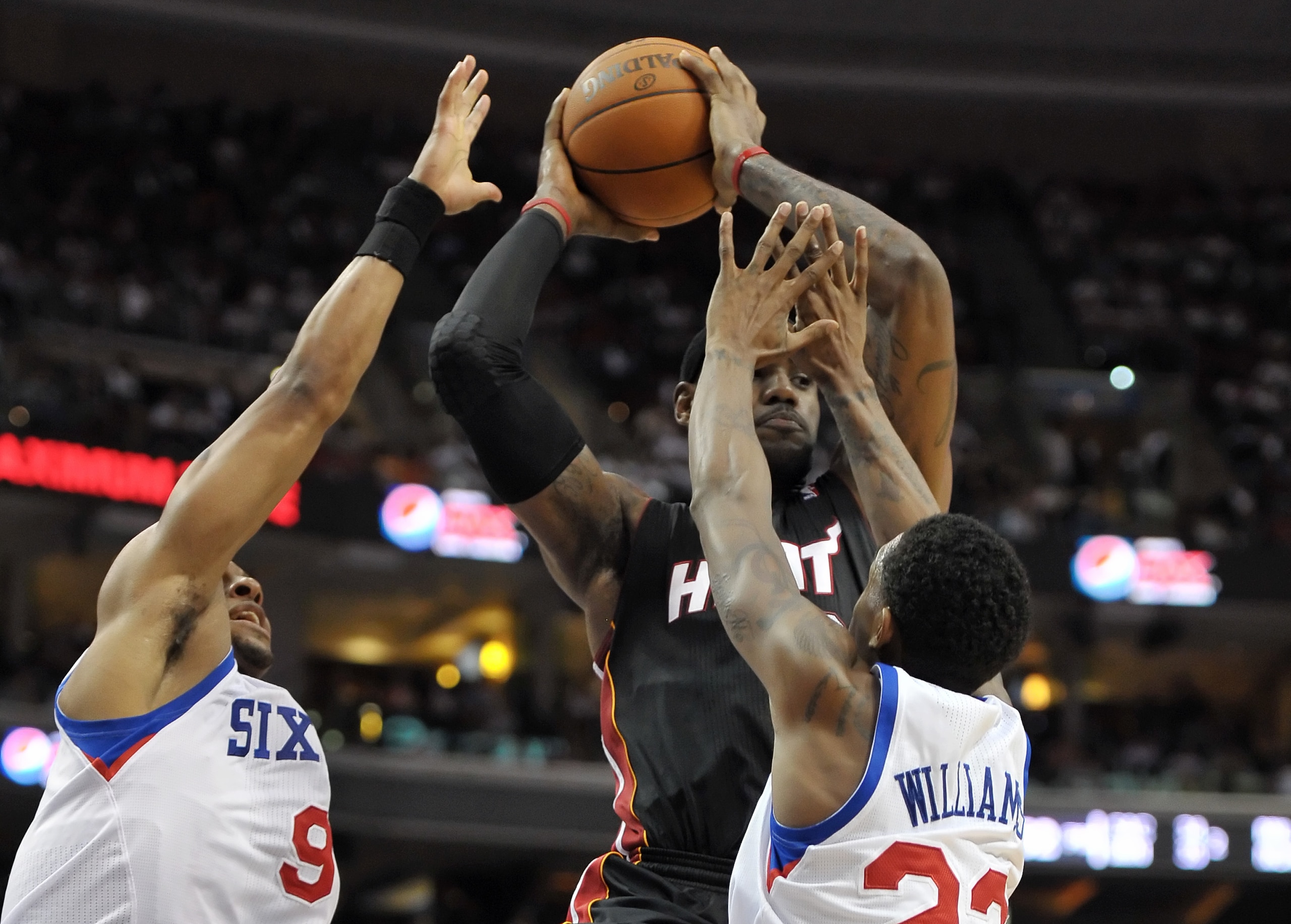 PHILADELPHIA - OCTOBER 27:  LeBron James #6 of the Miami Heat tries to pass the ball through Andre Iguodala #9 and Lou Williams #23 of the Philadelphia 76ers at the Wells Fargo Center on October 27, 2010 in Philadelphia, Pennsylvania. NOTE TO USER: User e