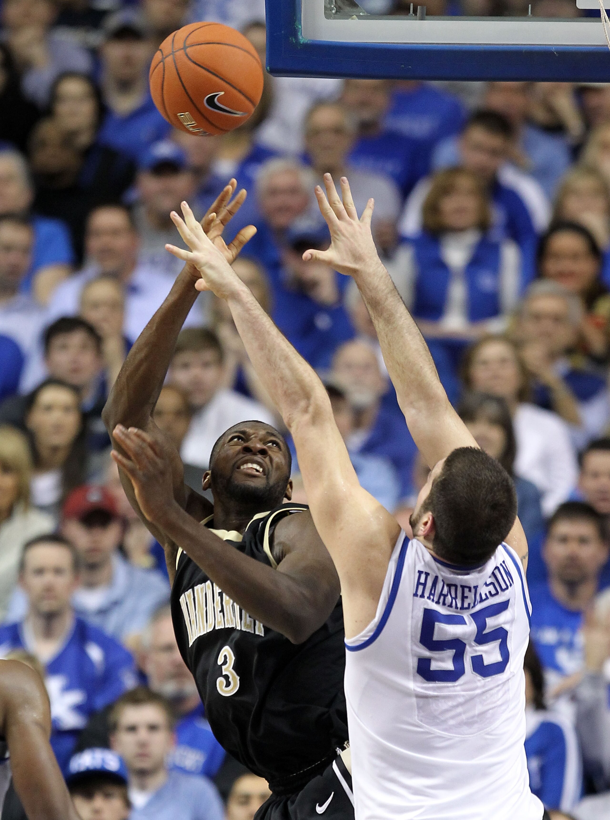 LEXINGTON, KY - MARCH 01:  Josh Harrellson #55 of the Kentucky Wildcats defends the shot of Festus Ezeli #3 of the Vanderbilt Commodores  during the SEC game at Rupp Arena on March 1, 2011 in Lexington, Kentucky.  (Photo by Andy Lyons/Getty Images)