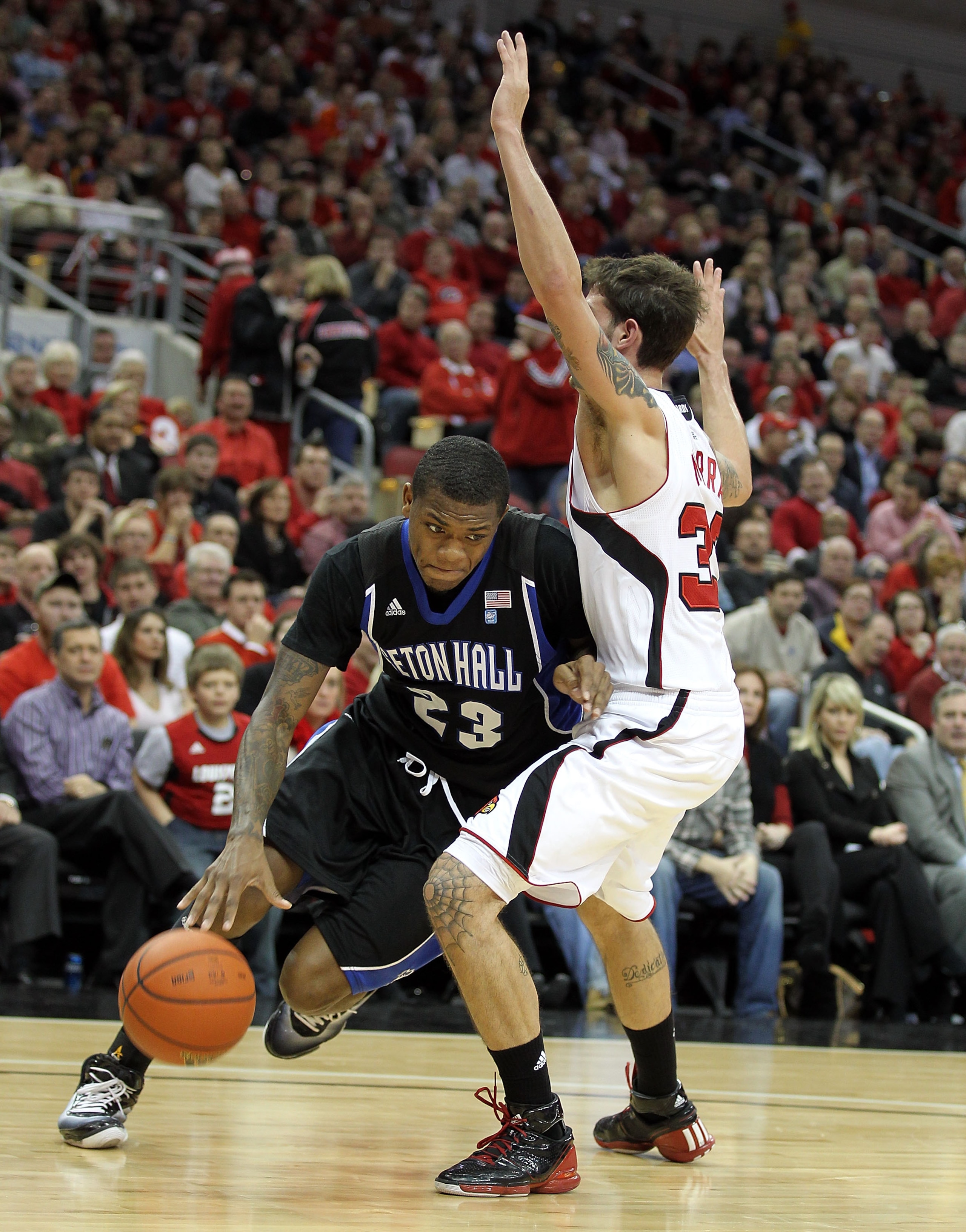 LOUISVILLE, KY - JANUARY 05: Fuquan Edwin #23 of the Seton Hall Pirates dribbles the ball while defended by Mike Marra #33 of the Louisville Cardinals during the Big East Conference game at the KFC Yum! Center on January 5, 2011 in Louisville, Kentucky. LOUISVILLE, KY - JANUARY 05: Fuquan Edwin #23 of the Seton Hall Pirates dribbles the ball while defended by Mike Marra #33 of the Louisville Cardinals during the Big East Conference game at the KFC Yum! Center on January 5, 2011 in Louisville, Kentucky.