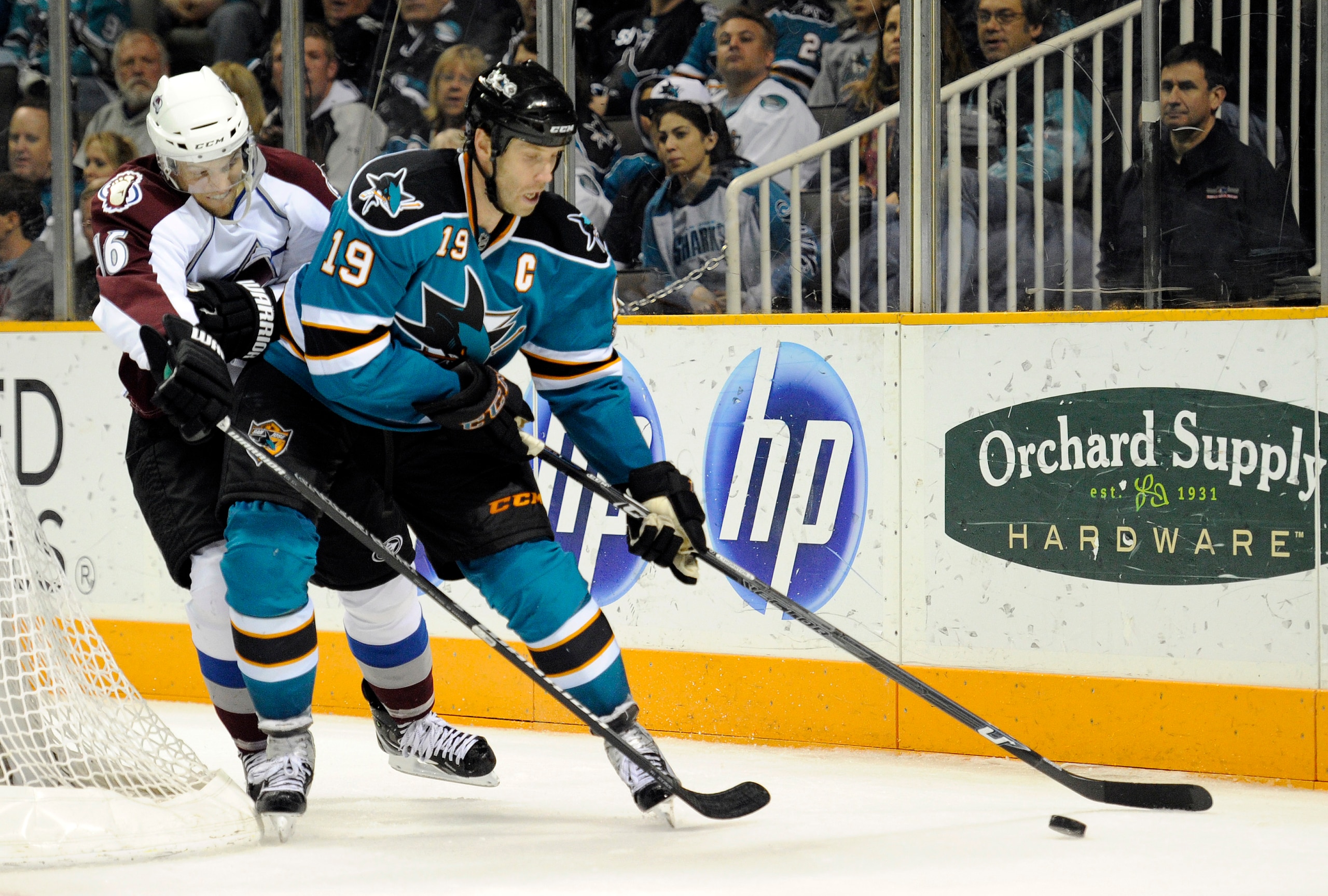 SAN JOSE, CA - MARCH 1: Joe Thornton #19 of the San Jose Sharks keeps the puck away from Jay McClement #16 of the Colorado Avalanche in the second period during an NHL hockey game at the HP Pavilion on March 1, 2011 in San Jose, California. (Photo by Thea