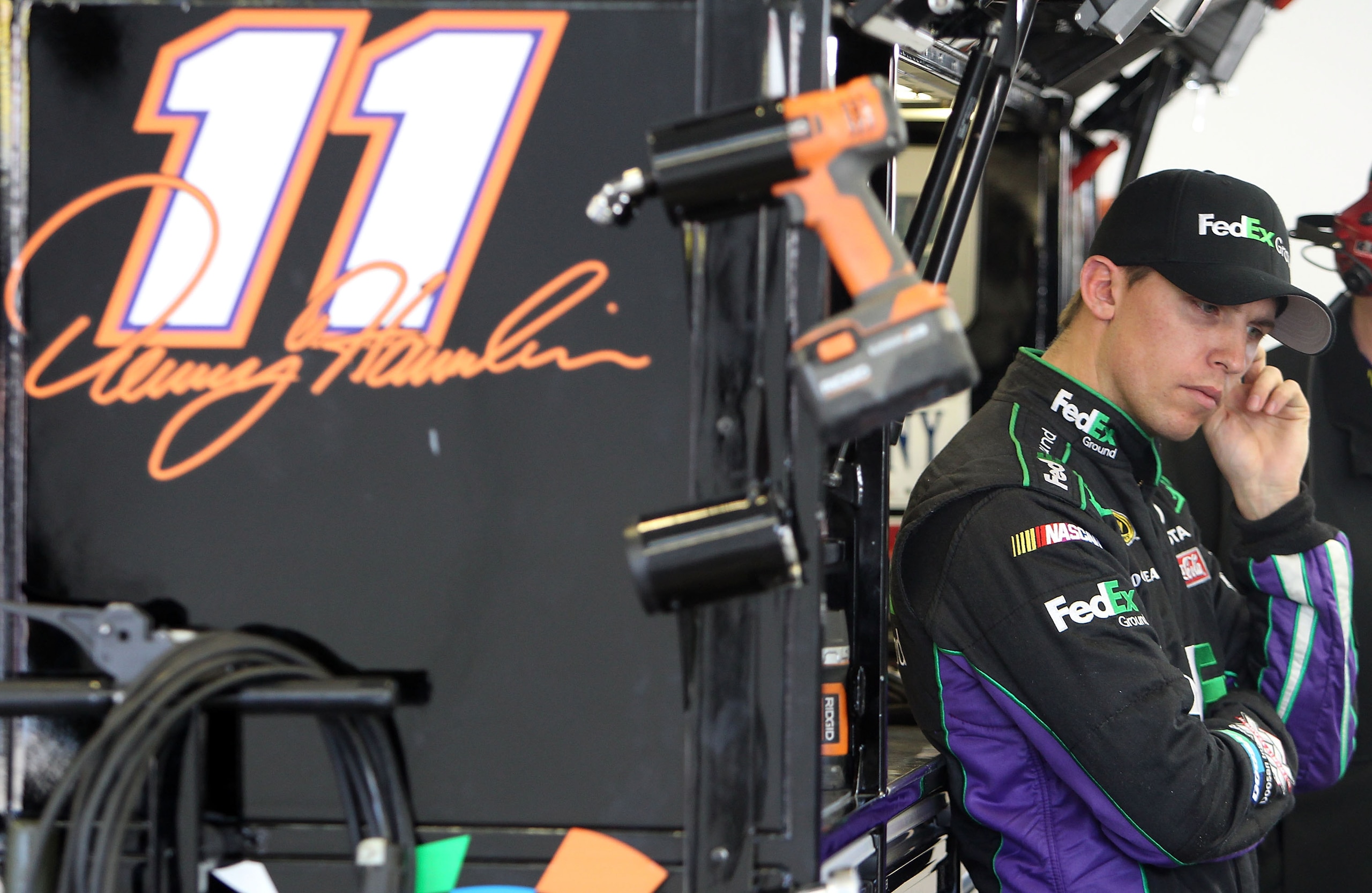LAS VEGAS, NV - MARCH 04:  Denny Hamlin, driver of the #11 FedEx Ground Toyota, stands in the garage during practice for the NASCAR Sprint Cup Series Kobalt Tools 400 at Las Vegas Motor Speedway on March 4, 2011 in Las Vegas, Nevada.  (Photo by Jonathan F