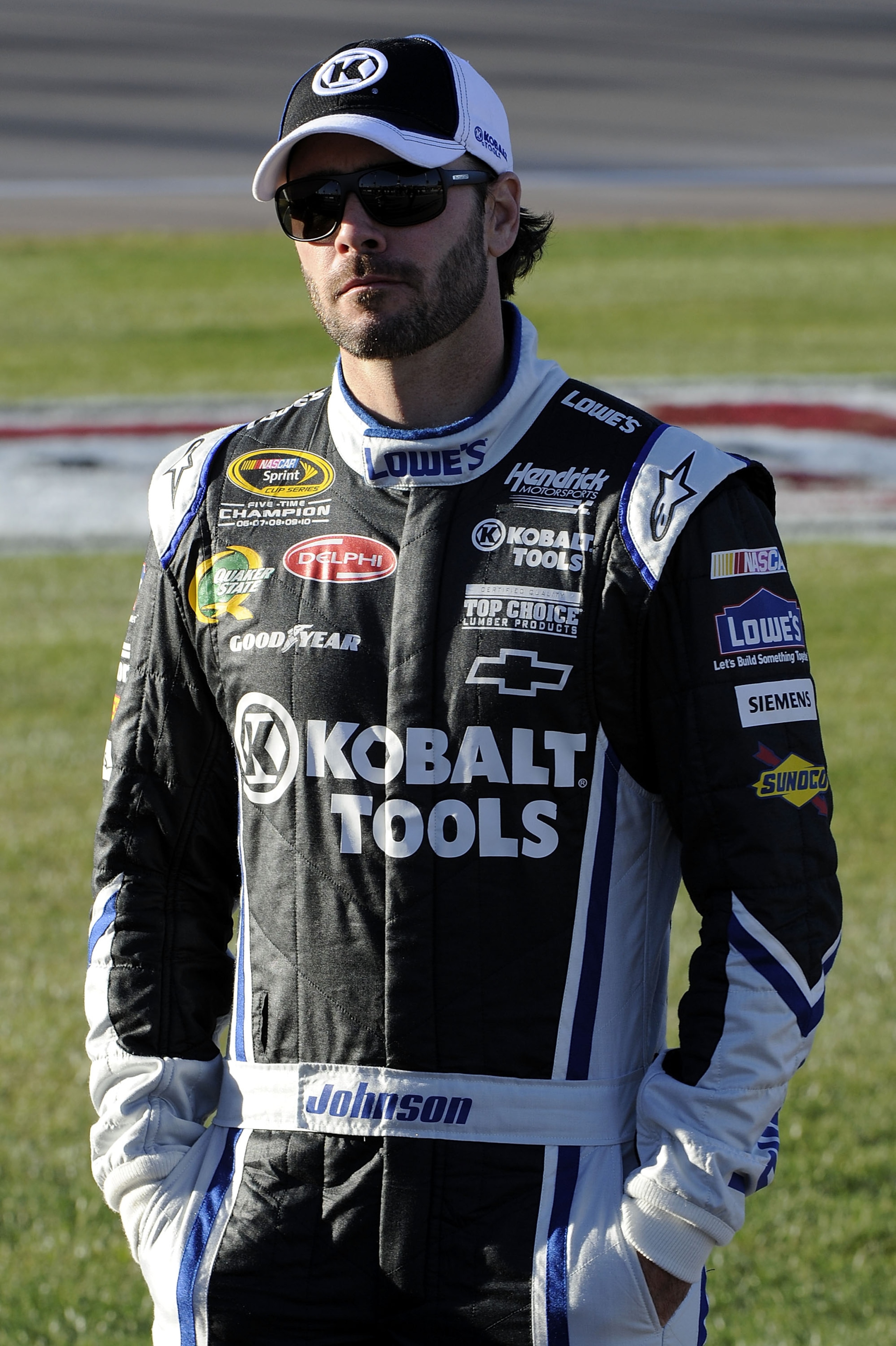 LAS VEGAS, NV - MARCH 04:  Jimmie Johnson, driver of the #48 Lowe's Chevrolet, stands on the grid during qualifying for the NASCAR Sprint Cup Series Kobalt Tools 400 at Las Vegas Motor Speedway on March 4, 2011 in Las Vegas, Nevada.  (Photo by John Harrel