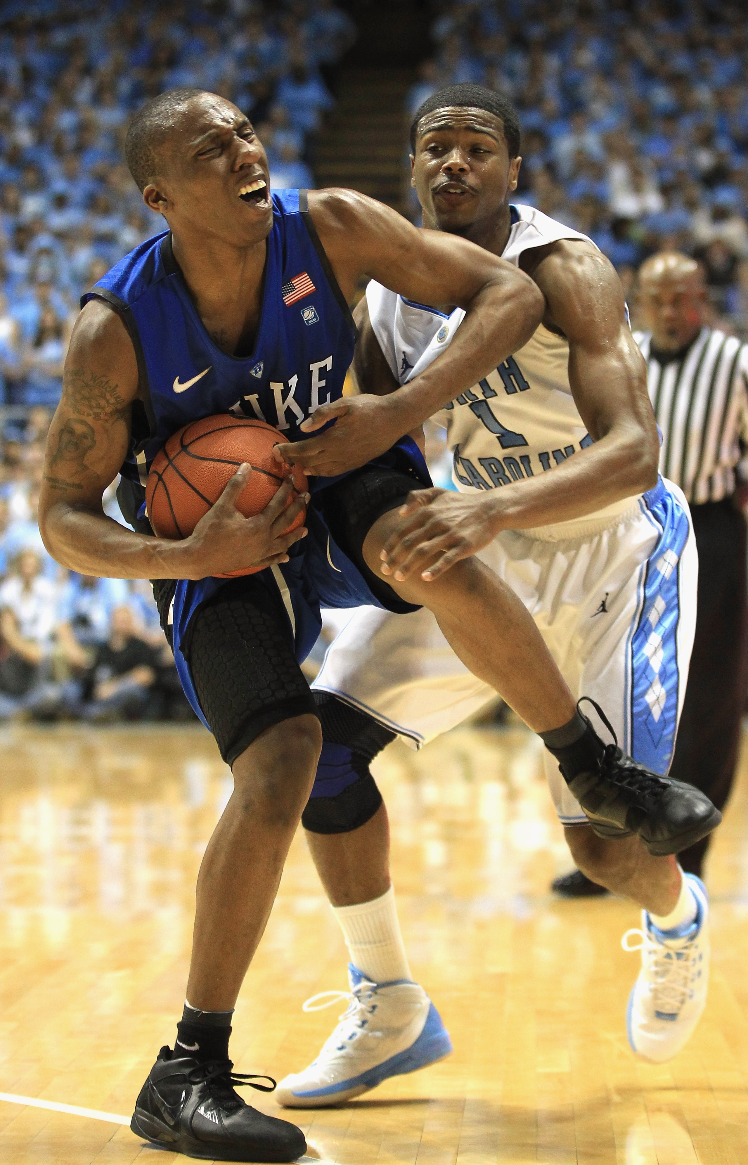 CHAPEL HILL, NC - MARCH 05: Nolan Smith #2 of the Duke Blue Devils reacts to running into Dexter Strickland #1 of the North Carolina Tar Heels during their game at the Dean E. Smith Center on March 5, 2011 in Chapel Hill, North Carolina. (Photo by Stree CHAPEL HILL, NC - MARCH 05: Nolan Smith #2 of the Duke Blue Devils reacts to running into Dexter Strickland #1 of the North Carolina Tar Heels during their game at the Dean E. Smith Center on March 5, 2011 in Chapel Hill, North Carolina. (Photo by Stree
