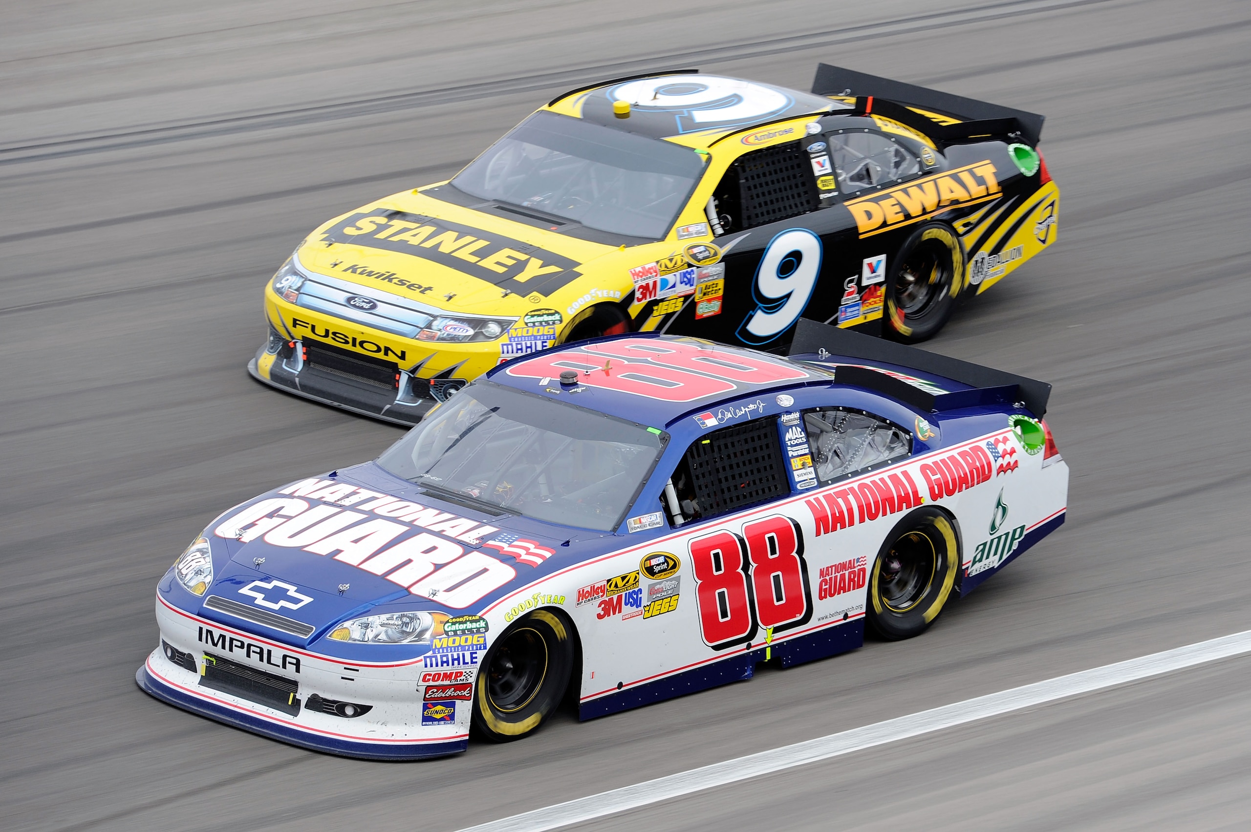 LAS VEGAS, NV - MARCH 06:  Dale Earnhardt Jr., driver of the #88 National Guard/Amp Energy Chevrolet, races Marcos Ambrose, driver of the #9 Stanley Ford, during the NASCAR Sprint Cup Series Kobalt Tools 400 at Las Vegas Motor Speedway on March 6, 2011 in