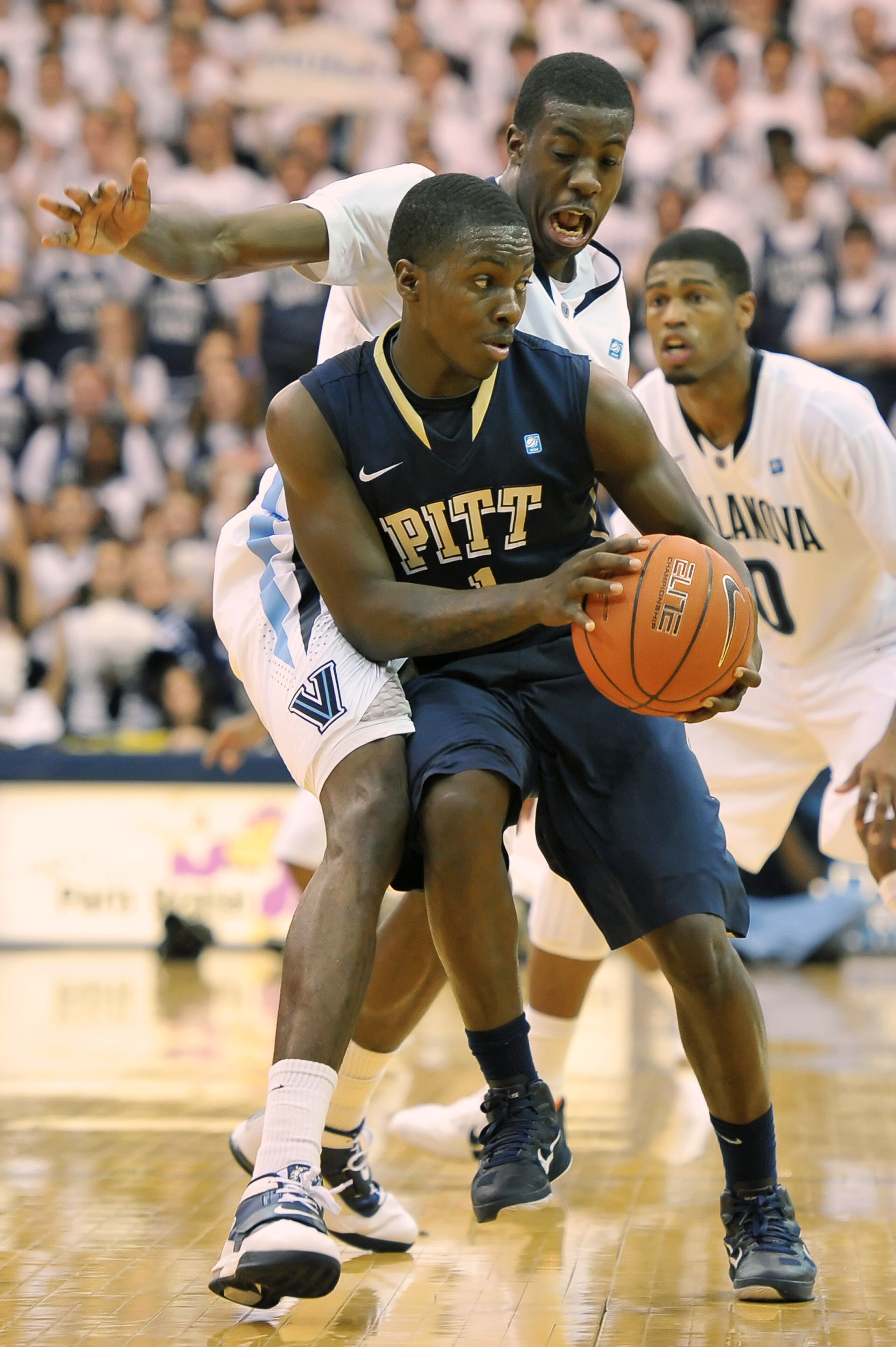 VILLANOVA, PA - FEBRUARY 12: Travon Woodall #1 of the Pittsburgh Panthers works his way around Isaiah Armwood #34 of the Villanova Wildcats at The Pavilion on February 12, 2011 in Villanova, Pennsylvania. Pittsburgh won 57-54.  (Photo by Drew Hallowell/Ge