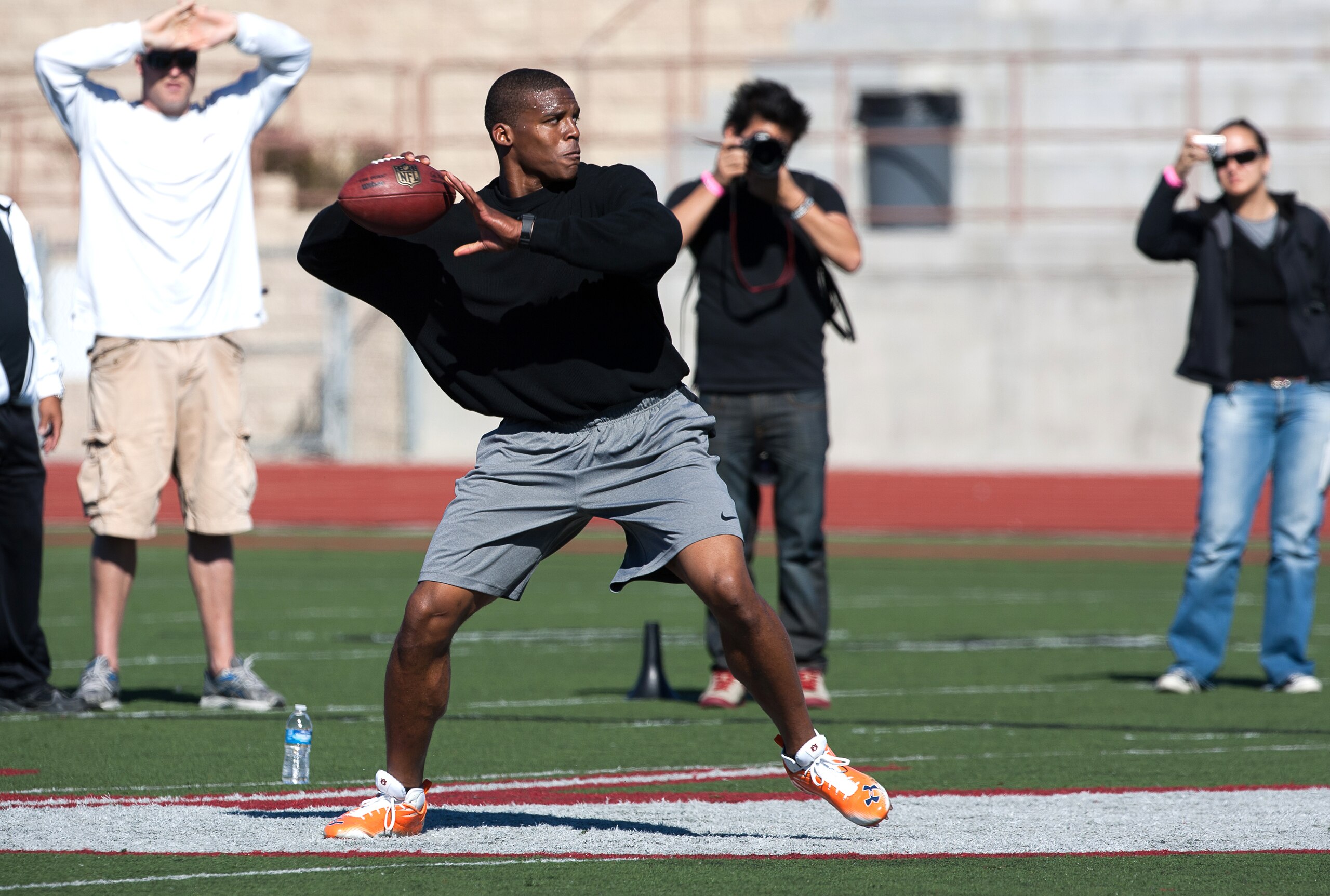 SAN DIEGO, CA - FEBRUARY 10: 2010 Heisman Trophy winning quarterback Cam Newton of Auburn throws the ball during his workout routine for the media at Cathedral High School's sports stadium on February 10, 2011 in San Diego, California. (Photo by Kent Horn
