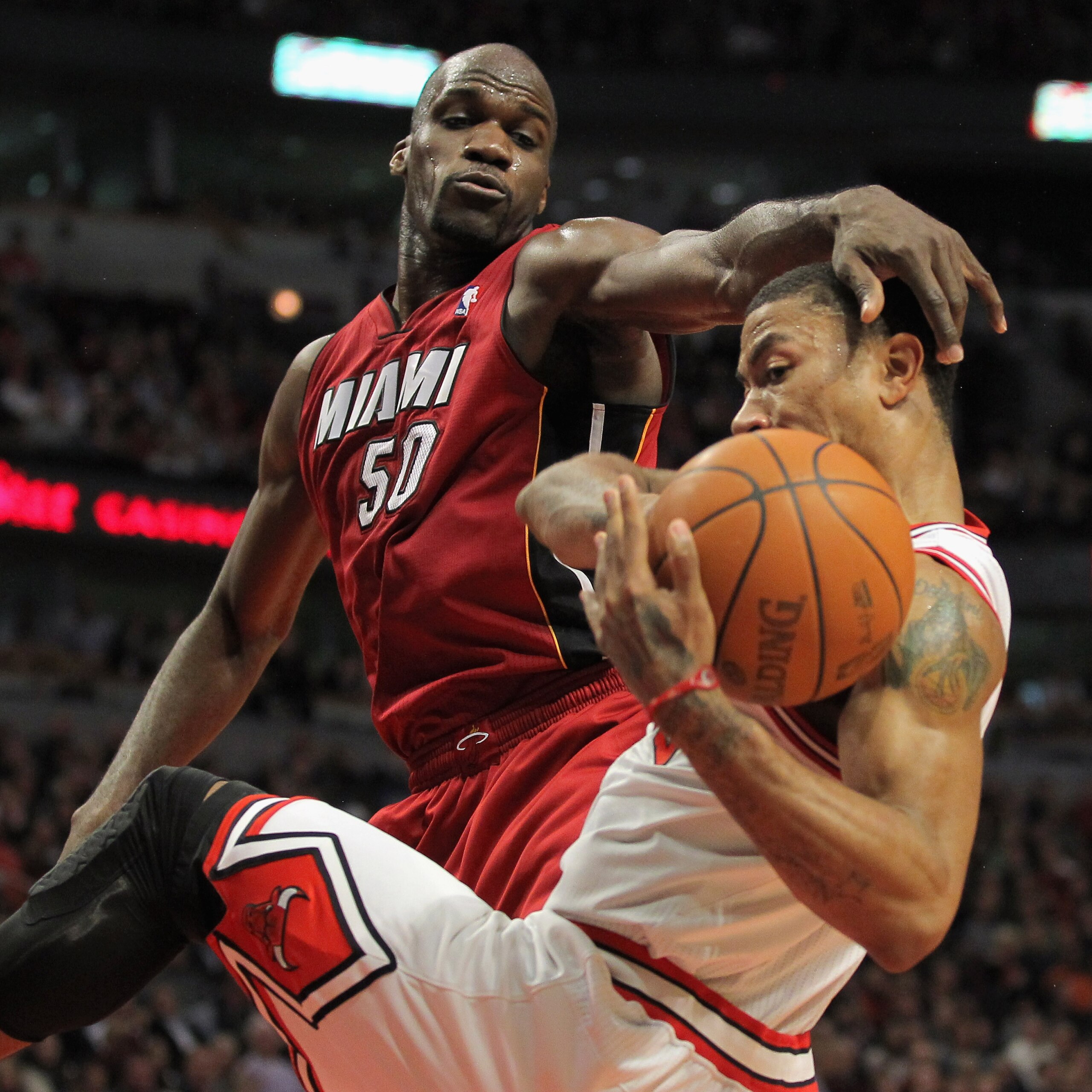 CHICAGO, IL - JANUARY 15:  Derrick Rose #1 of the Chicago Bulls is fouled by Joel Anthony #50 of the Miami Heat at the United Center on January 15, 2011 in Chicago, Illinois. NOTE TO USER: User expressly acknowledges and agrees that, by downloading and or