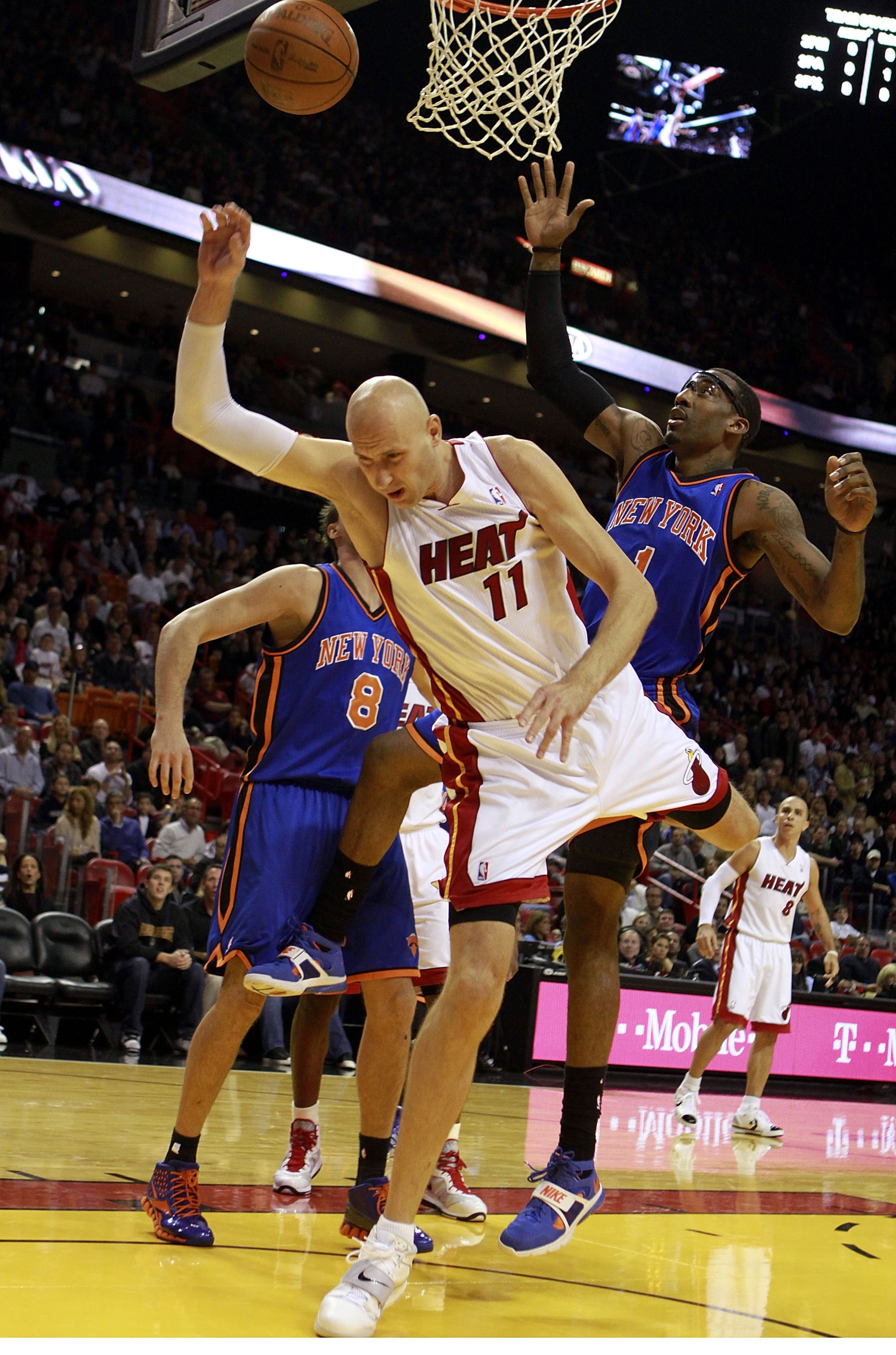 MIAMI - DECEMBER 28: Center Zydrunas Ilgauskas #11 of the Miami Heat is fouled by Forward Amar'e Stoudemire #1 and Ronnie Turiaf #14 of the New York Knicks game at American Airlines Arena on December 28, 2010 in Miami, Florida.  (Photo by Marc Serota/Gett