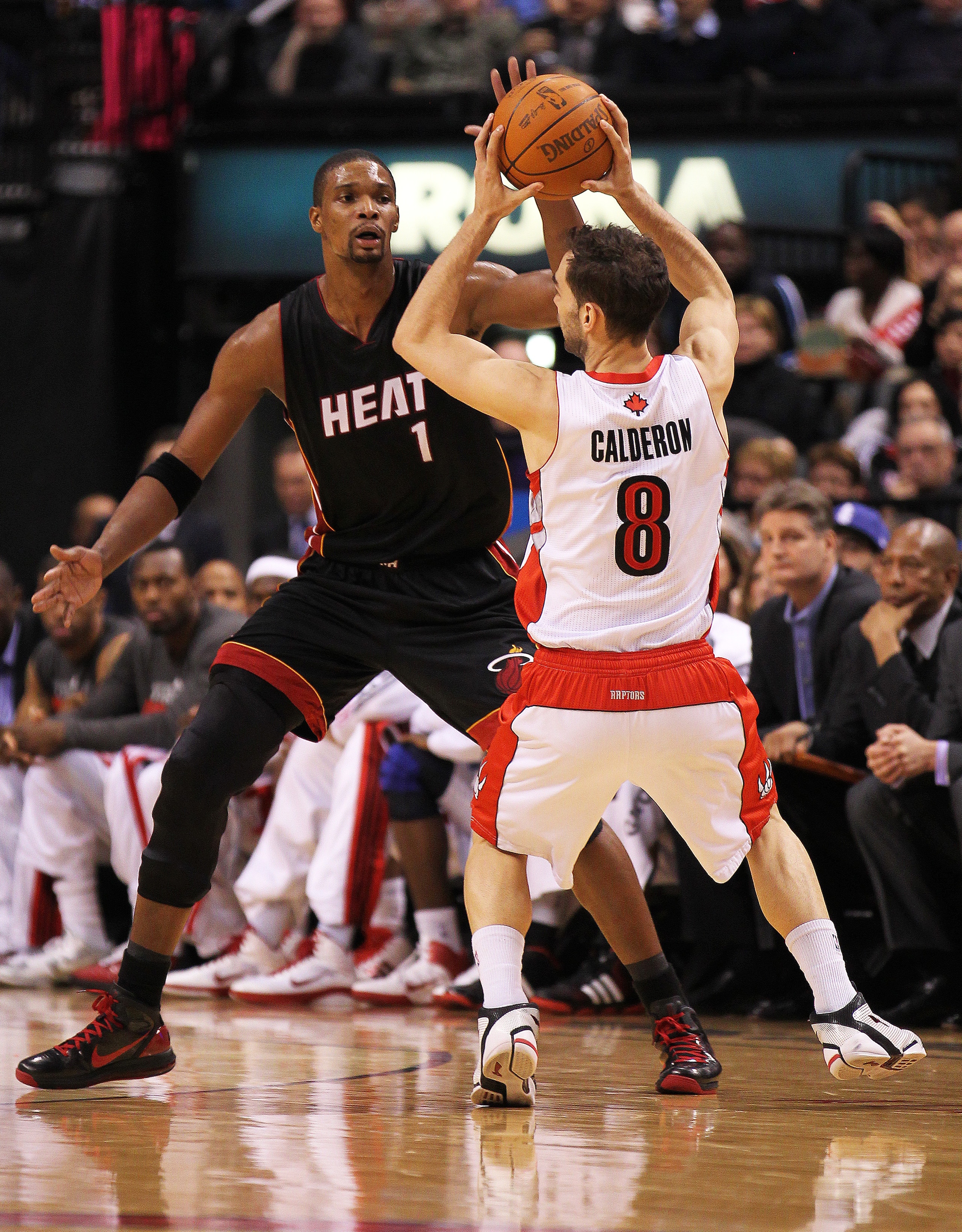 TORONTO, CAN - FEBRUARY 16:  Chris Bosh #1 of the Miami Heat defends against Jose Calderon #8 of the Toronto Raptors in a game on February 16, 2011 at the Air Canada Centre in Toronto, Canada. The Heat defeated the Raptors 103-95. (Photo by Claus Andersen