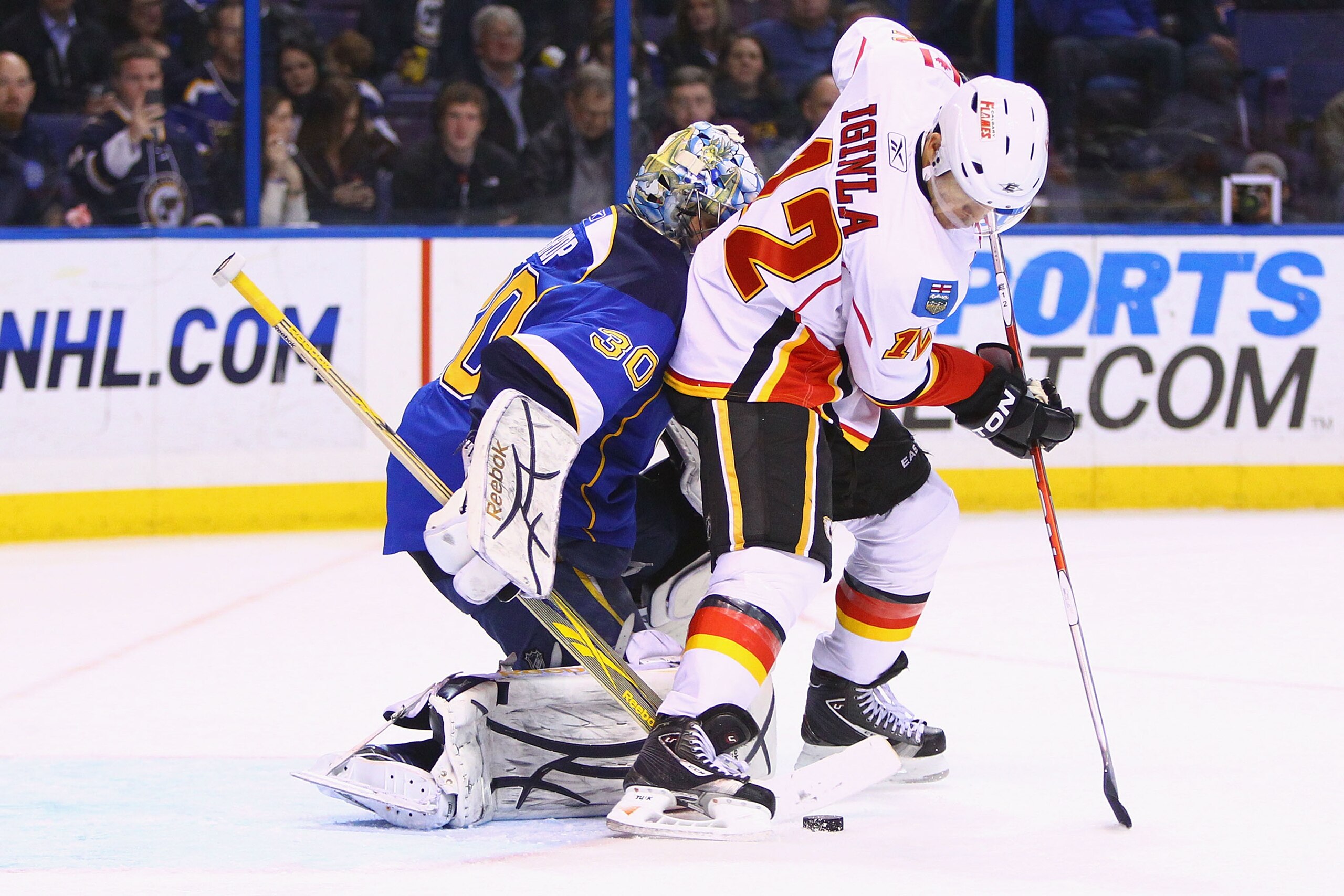 ST. LOUIS, MO - MARCH 1: Jarome Iginla #12 of the Calgary Flames backs into Ben Bishop #30 of the St. Louis Blues at the Scottrade Center on March 1, 2011 in St. Louis, Missouri.  (Photo by Dilip Vishwanat/Getty Images)
