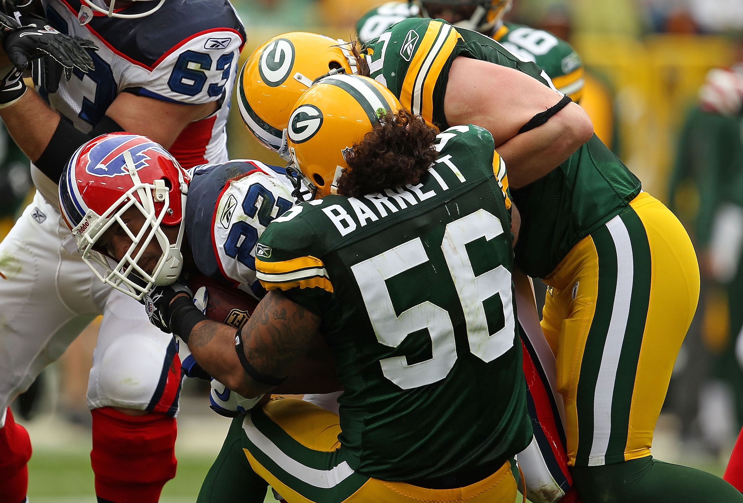 GREEN BAY, WI - SEPTEMBER 19: Fred Jackson #22 of the Buffalo Bills is tackled by Nick Barnett #56 and A.J. Hawk #50 of the Green Bay Packers at Lambeau Field on September 19, 2010 in Green Bay, Wisconsin. The Packers defeated the Bills 34-7.  (Photo by J