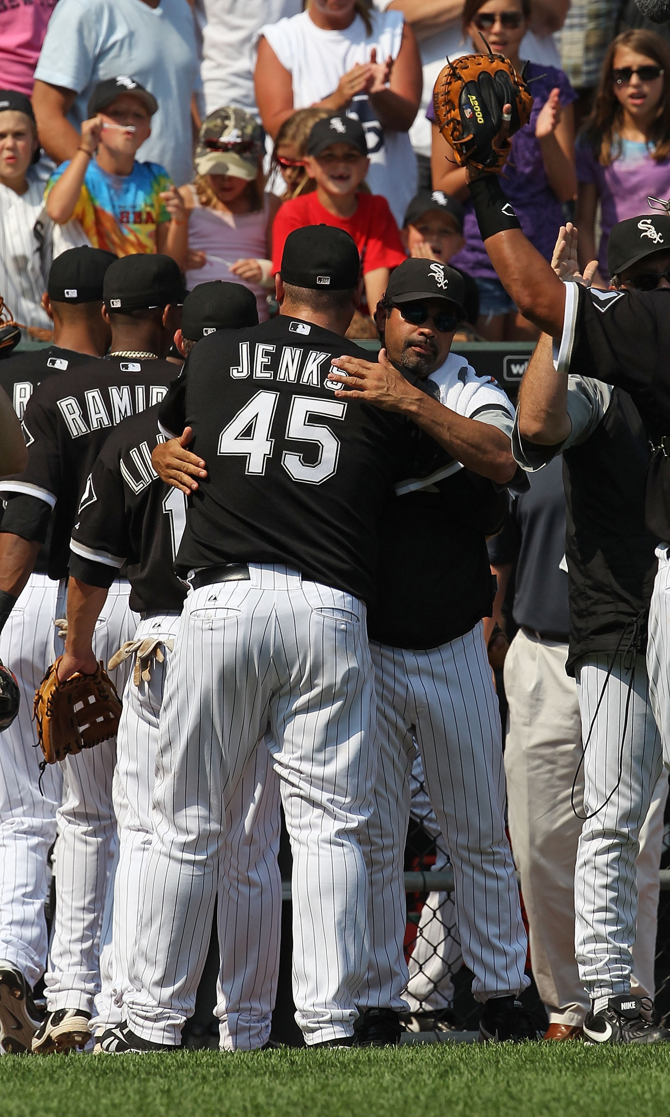CHICAGO - AUGUST 01: Manager Ozzie Guillen #13 of the Chicago White Sox hugs closing pitcher Bobby Jenks #45 after a win over the Oakland Athletics at U.S. Cellular Field on August 1, 2010 in Chicago, Illinois. The White Sox defeated the Athletics 4-1. (P