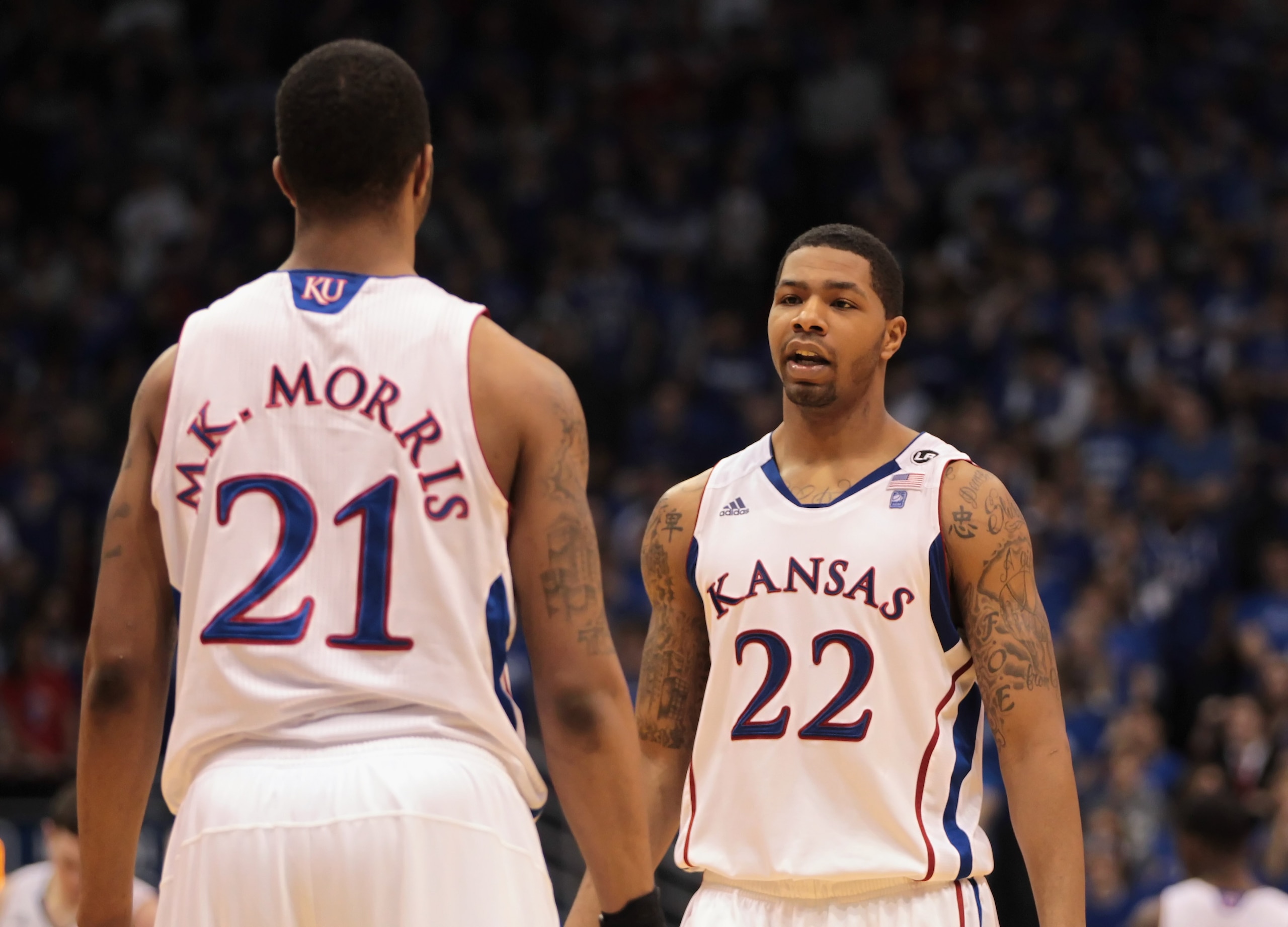 LAWRENCE, KS - FEBRUARY 12:  Marcus Morris #22 of the Kansas Jayhawks talks with his brother Markieff Morris #21 during the game against the Iowa State Cyclones on February 12, 2011 at Allen Fieldhouse in Lawrence, Kansas.  (Photo by Jamie Squire/Getty Im
