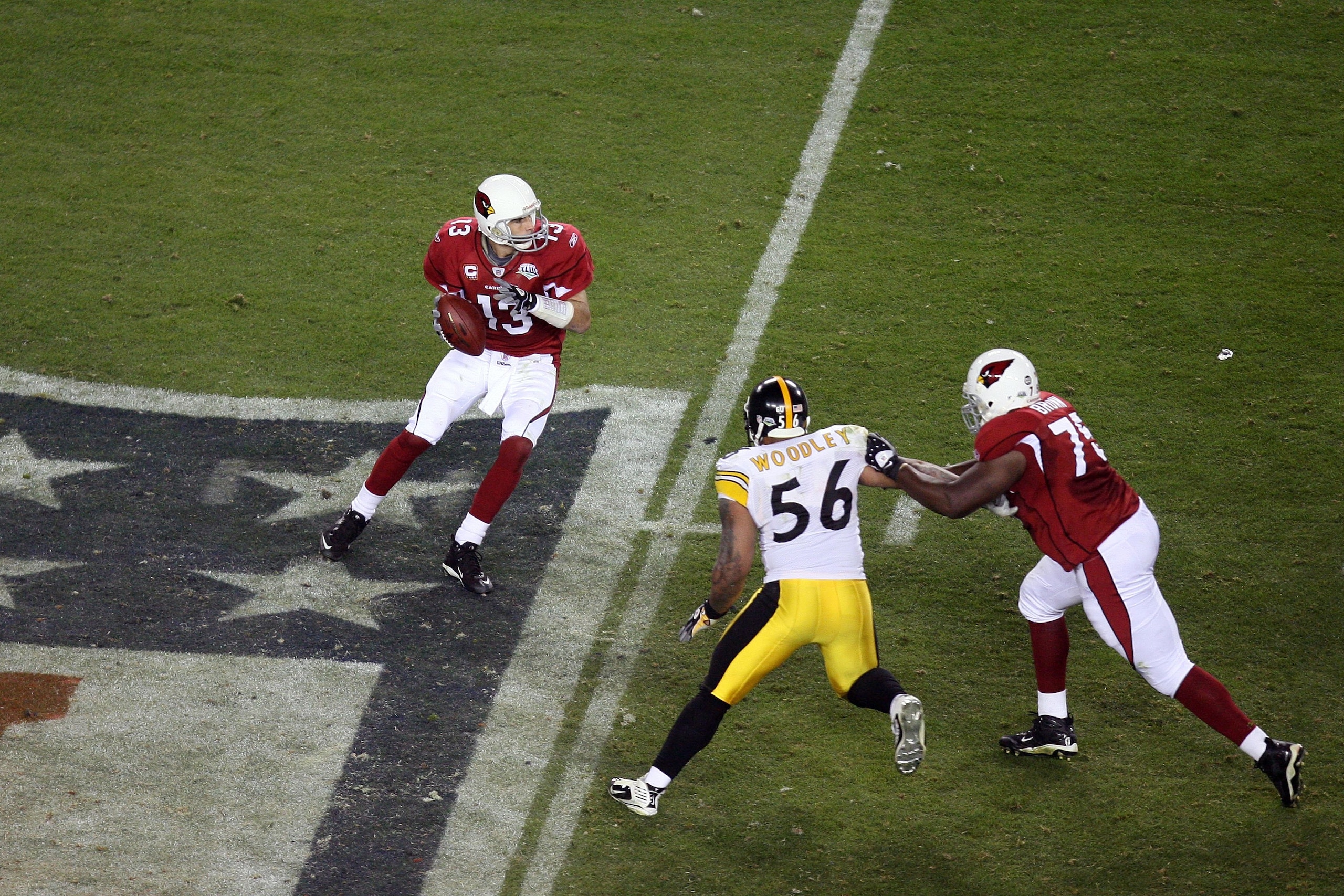 TAMPA, FL - FEBRUARY 01:  Kurt Warner #13 of the Arizona Cardinals looks to pass as Levi Brown #75 attempts to block LaMarr Woodley #56 of the Pittsburgh Steelers during Super Bowl XLIII on February 1, 2009 at Raymond James Stadium in Tampa, Florida. Stee