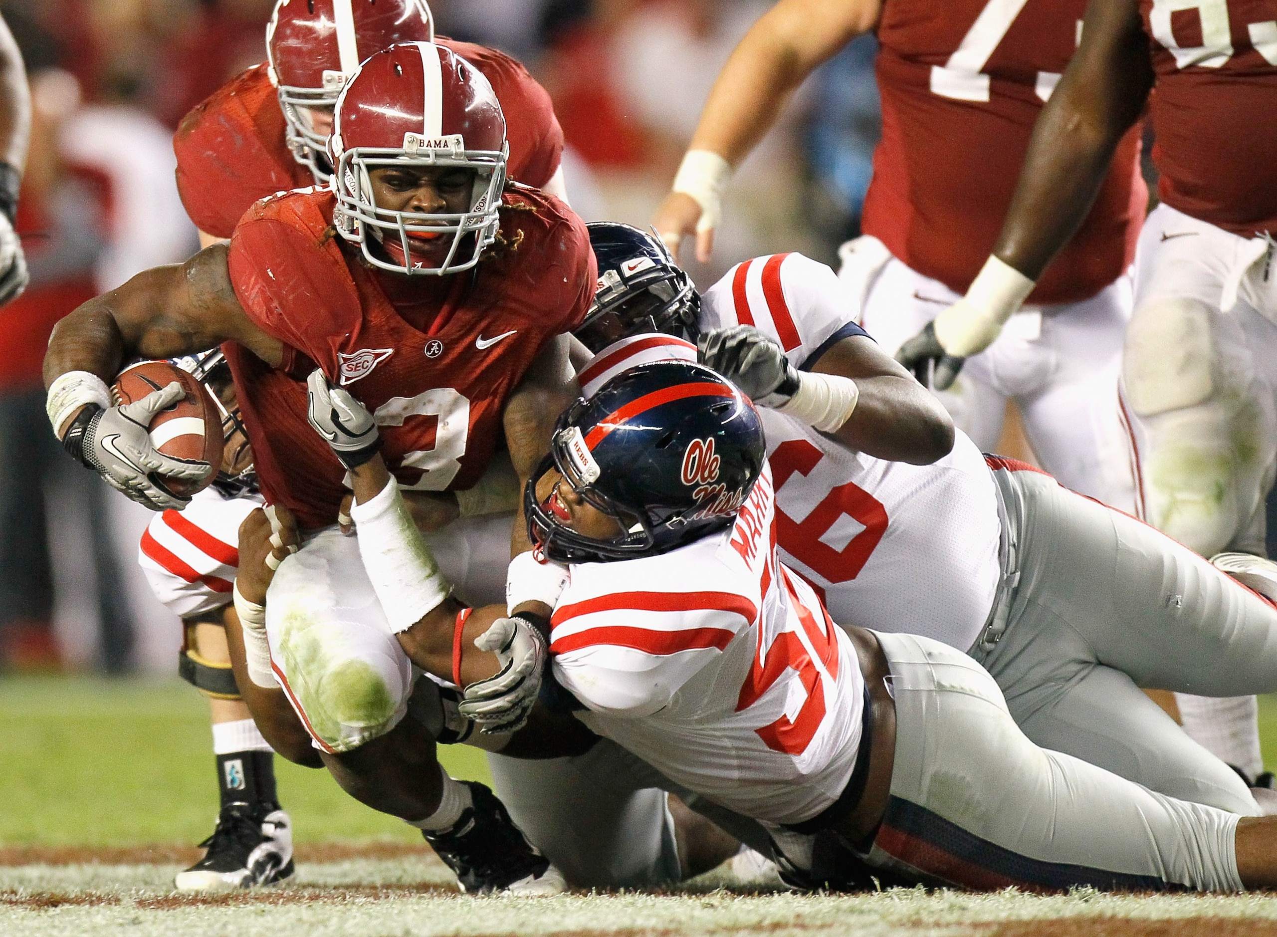 TUSCALOOSA, AL - OCTOBER 16:  Trent Richardson #3 of the Alabama Crimson Tide pushes for more yardage against Mike Marry #52 and Lawon Scott #96 of the Ole Miss Rebels at Bryant-Denny Stadium on October 16, 2010 in Tuscaloosa, Alabama.  (Photo by Kevin C.