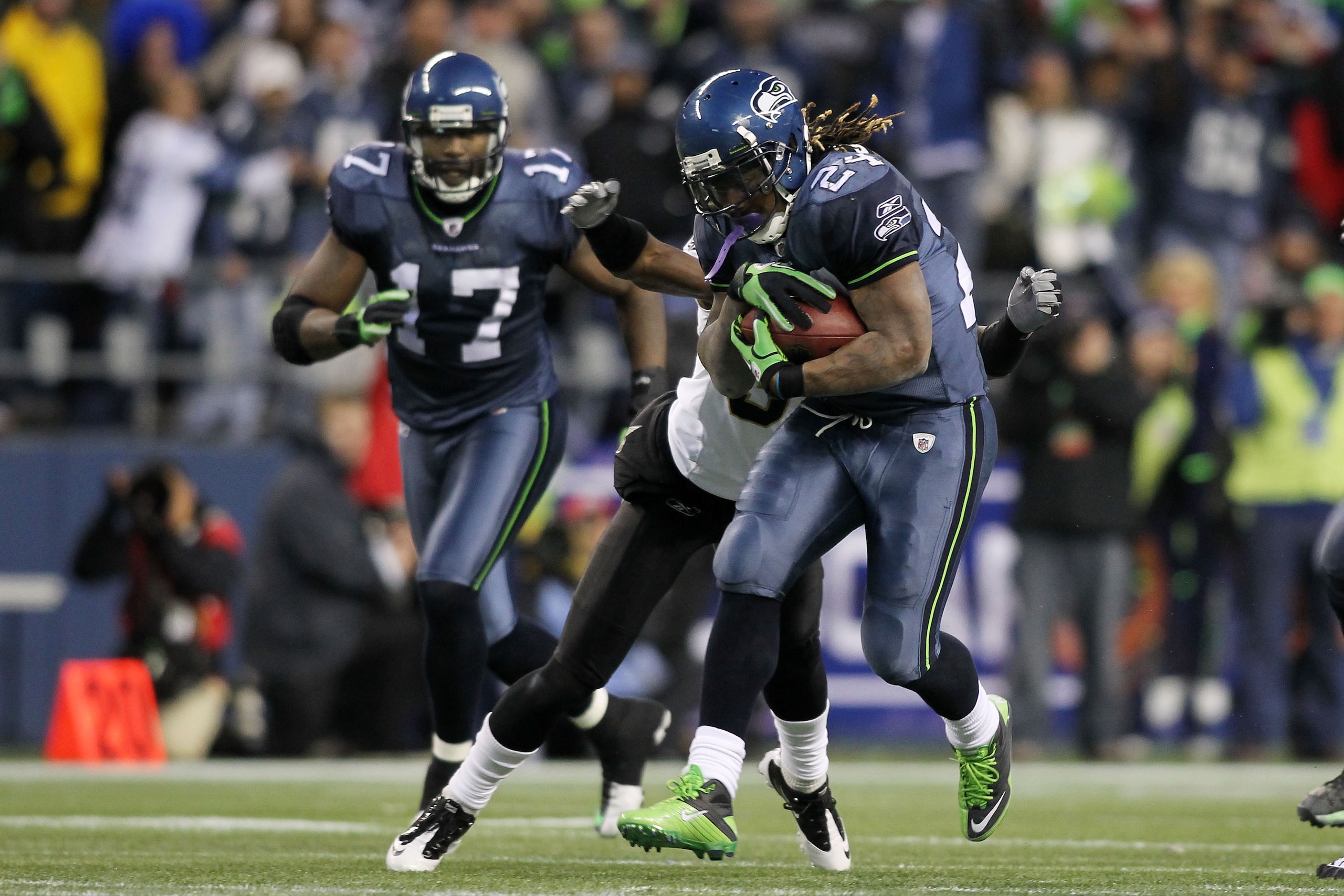 SEATTLE, WA - JANUARY 08:  Running back Marshawn Lynch #24 of the Seattle Seahawks runs for a 67-yard touchdown in the fourth quarter against the New Orleans Saints during the 2011 NFC wild-card playoff game at Qwest Field on January 8, 2011 in Seattle, W