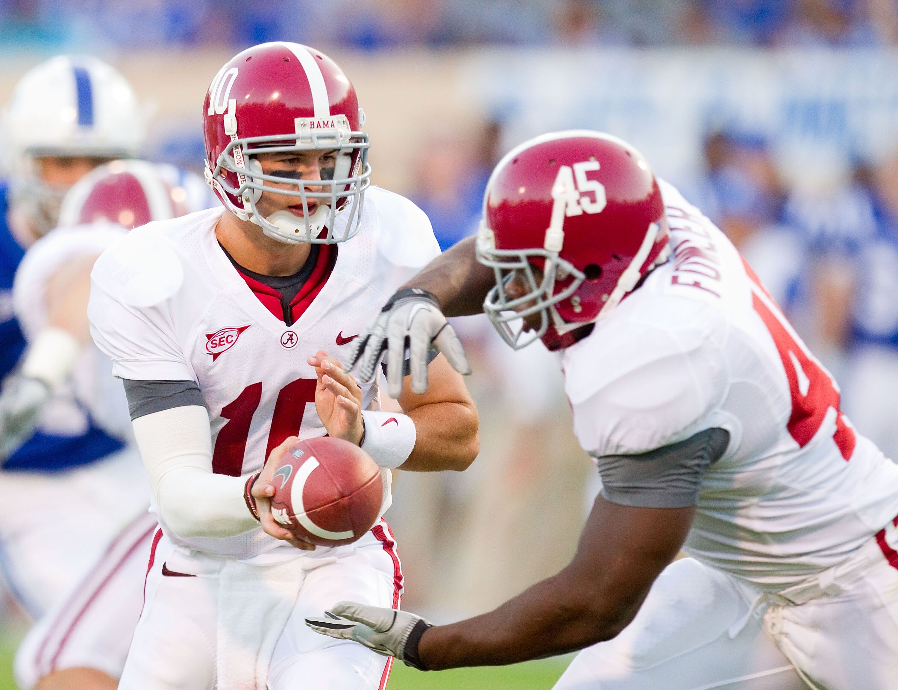 DURHAM, NC - SEPTEMBER 18: A.J. McCarron #10 of the Alabama Crimson Tide hands the ball off to Jalston Fowler #45 during fourth quarter action against the Duke Blue Devils at Wallace Wade Stadium on September 18, 2010 in Durham, North Carolina.  The Crims