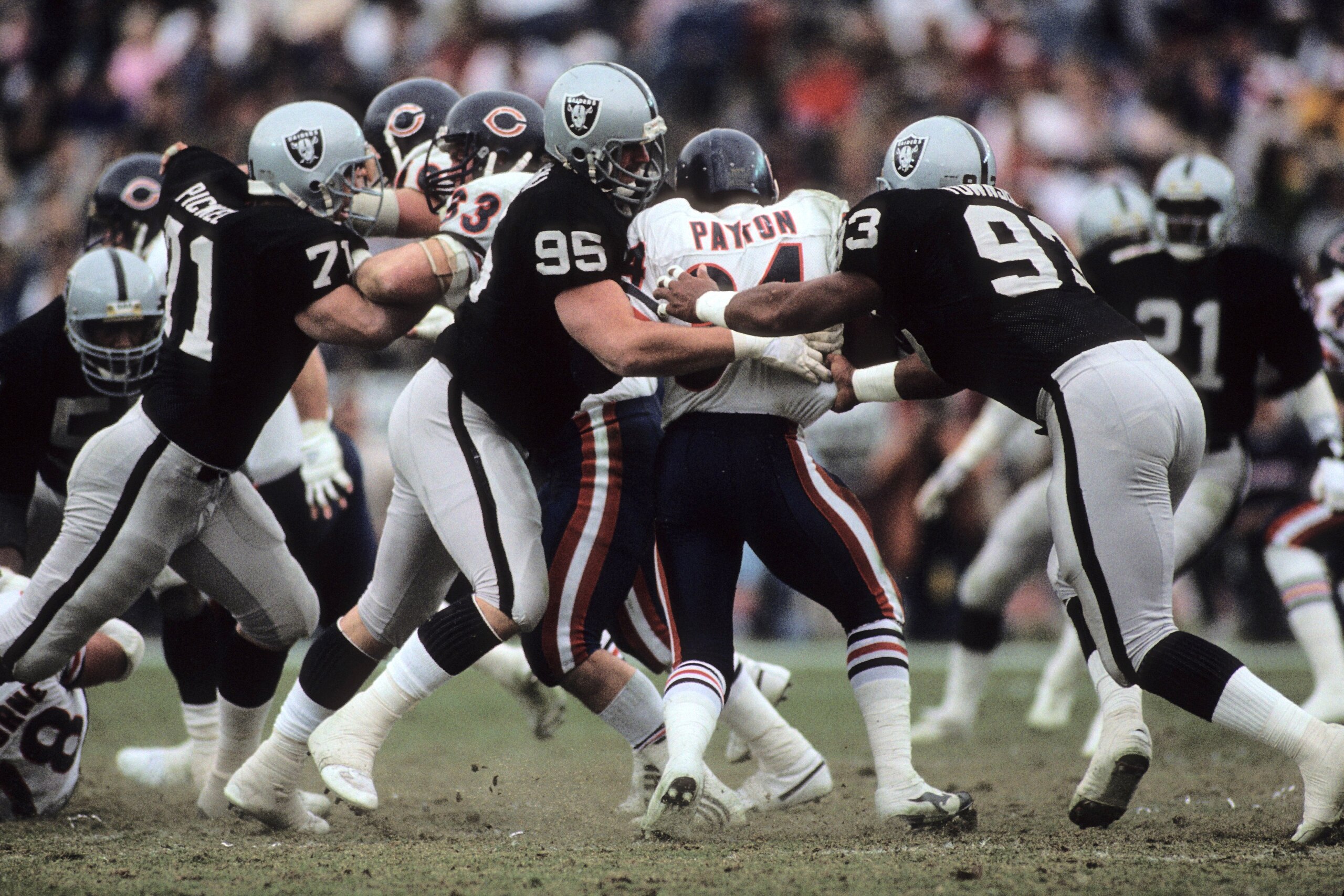 LOS ANGELES, CA - DECEMBER 27:  Bob Buczkowski #95 and Greg Townsend #93 of the Los Angeles Raiders tackle running back Walter Payton #34 of the Chicago Bears during the game at the Los Angeles Memorial Coliseum on December 27, 1987 in Los Angeles, Califo