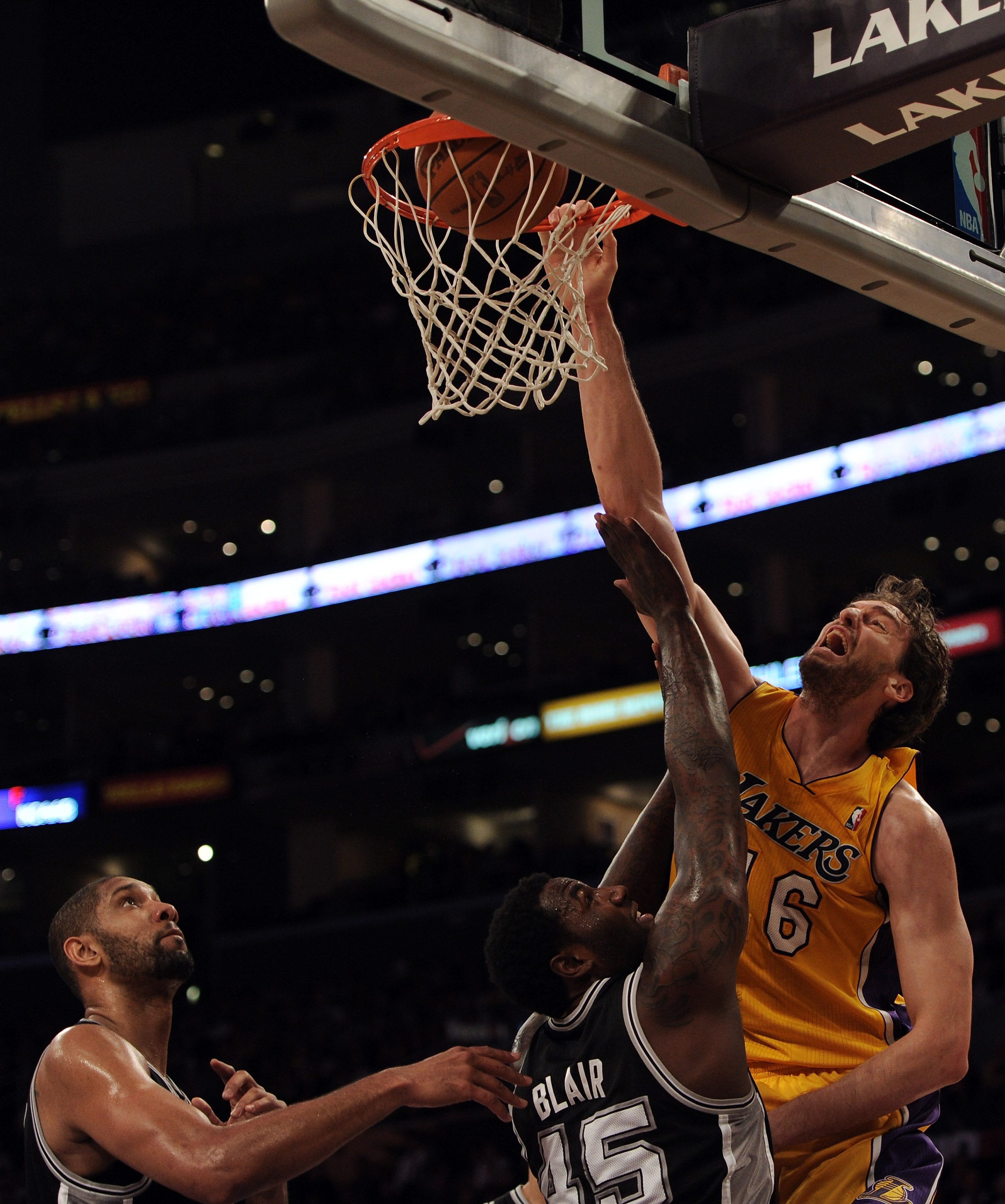 LOS ANGELES, CA - FEBRUARY 03:  Pau Gasol #16 of the Los Angeles Lakers dunks in front of DeJuan Blair #45 and Tim Duncan #21 of the San Antonio Spurs at Staples Center on February 3, 2011 in Los Angeles, California.  NOTE TO USER: User expressly acknowle