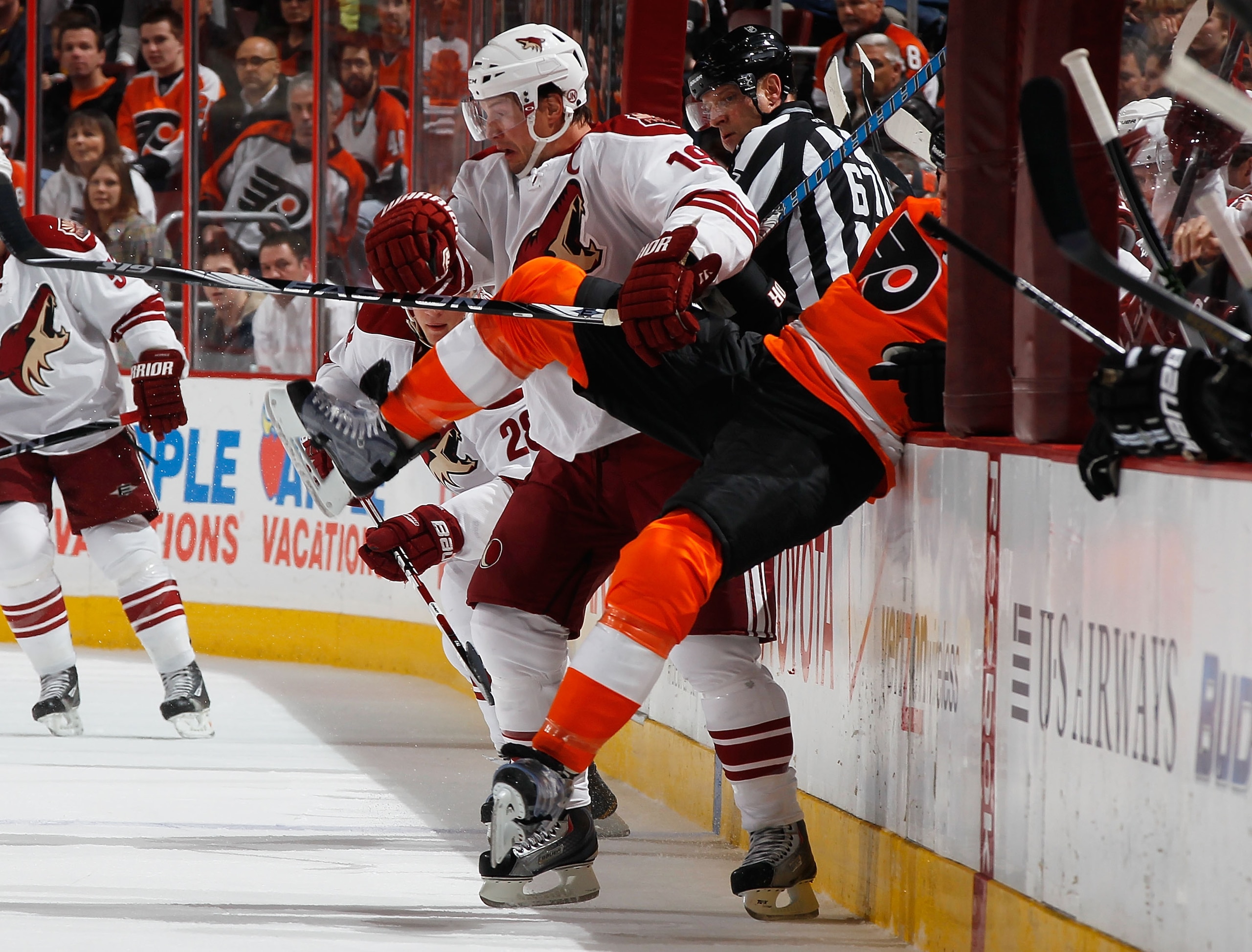 PHILADELPHIA - FEBRUARY 22:  Shane Doan #19 of the Phoenix Coyotes knocks Chris Pronger #20 of the Philadelphia Flyers into the boards on February 22, 2011 at the Wells Fargo Center in Philadelphia, Pennsylvania. Tonight marks Doan's 1,098th game with the
