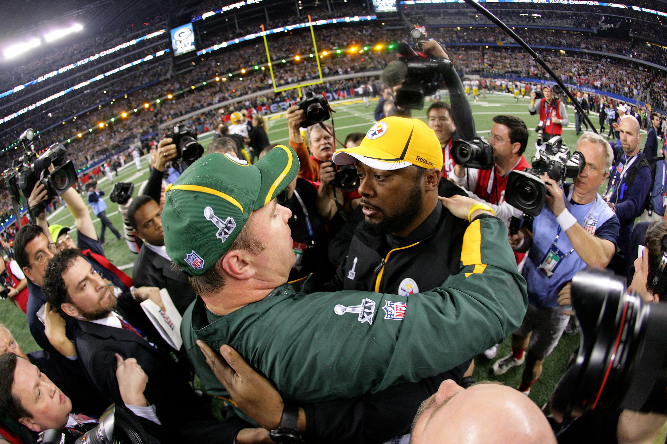 ARLINGTON, TX - FEBRUARY 06:  Head coach Mike McCarthy of the Green Bay Packers and head coach Mike Tomlin of the Pittsburgh Steelers speak after Green Bay wins Super Bowl XLV 31-25 at Cowboys Stadium on February 6, 2011 in Arlington, Texas.  (Photo by Al