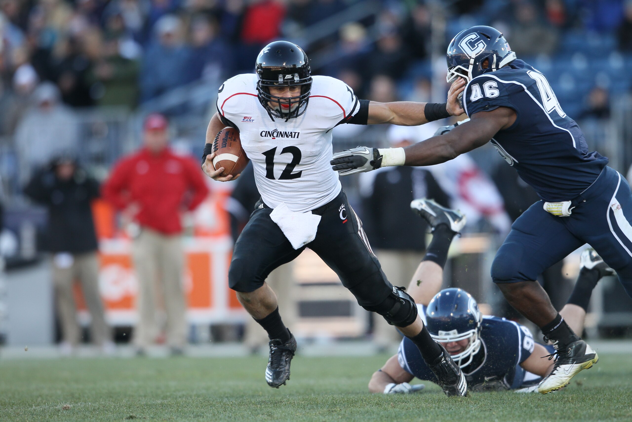 EAST HARTFORD, CT - NOVEMBER 27:  Zach Collaros #12 of the Cincinnati Bearcats carries the ball as Sio Moore #46 of the Connecticut Huskies makes the tackle on November 27, 2010 at Rentschler Field in East Hartford, Connecticut. The Huskies defeated the B