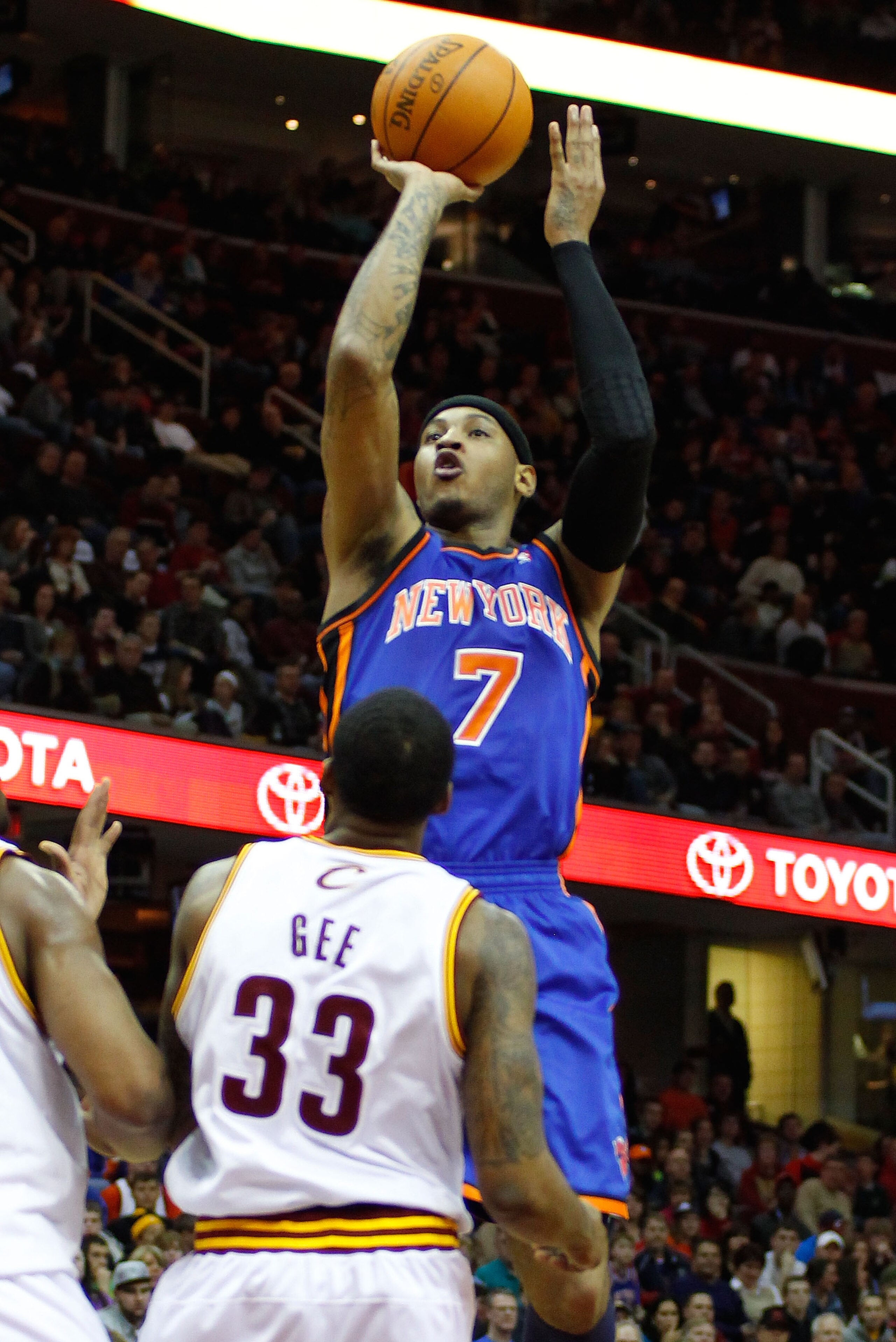 CLEVELAND - FEBRUARY 25:  Carmelo Anthony #7 of the New York Knicks attempts a shot over Alonzo Gee #33 of the Cleveland Cavaliers during the game on February 25, 2011 at Quicken Loans Arena in Cleveland, Ohio.  NOTE TO USER: User expressly acknowledges a