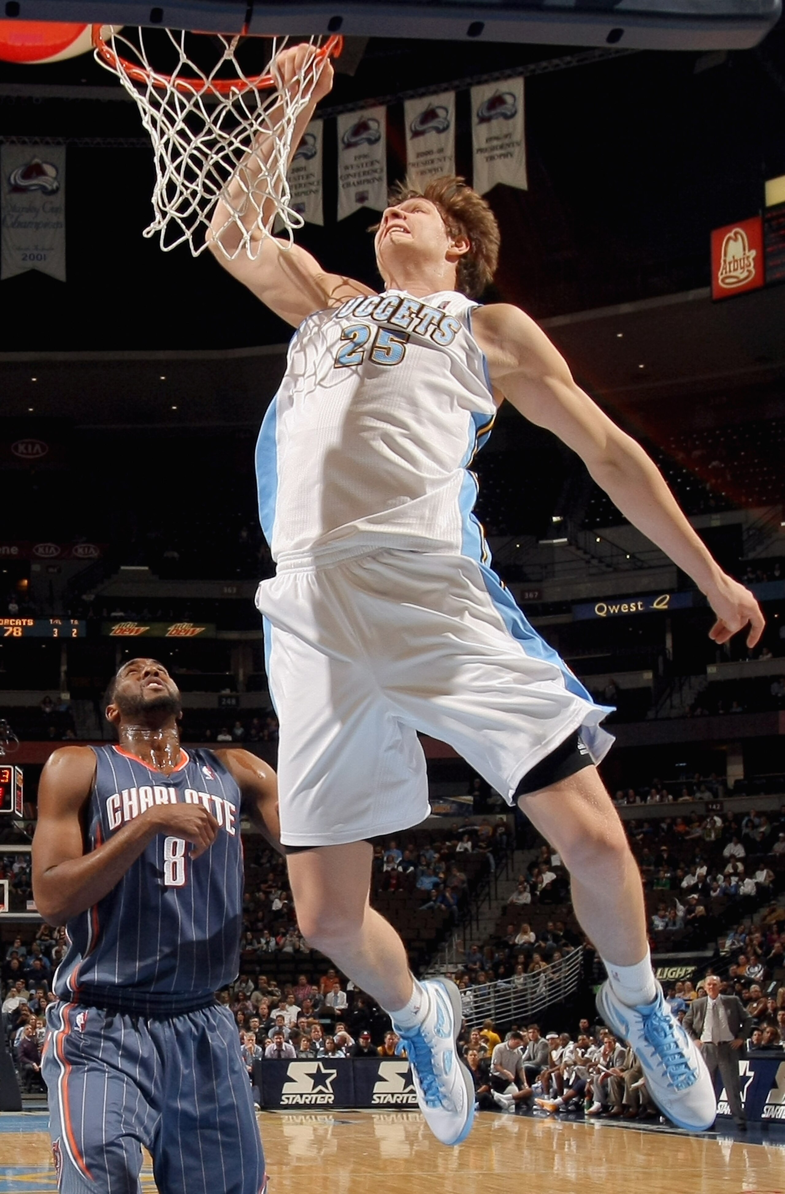 DENVER, CO - MARCH 02:  Timofey Mozgoz #25 of the Denver Nuggets goes to the rim against D.J. White #8 of the Charlotte Bobcats at the Pepsi Center on March 2, 2011 in Denver, Colorado. The Nuggets defeated the Bobcats 120-80.NOTE TO USER: User expressly