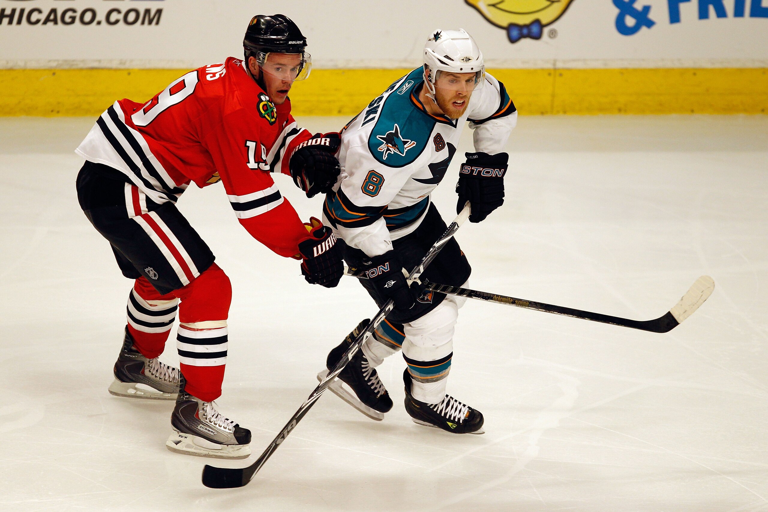 CHICAGO - MAY 23:  Jonathan Toews #19 of the Chicago Blackhawks skates with Joe Pavelski #8 of the San Jose Sharks in Game Four of the Western Conference Finals during the 2010 NHL Stanley Cup Playoffs at the United Center on May 23, 2010 in Chicago, Illi
