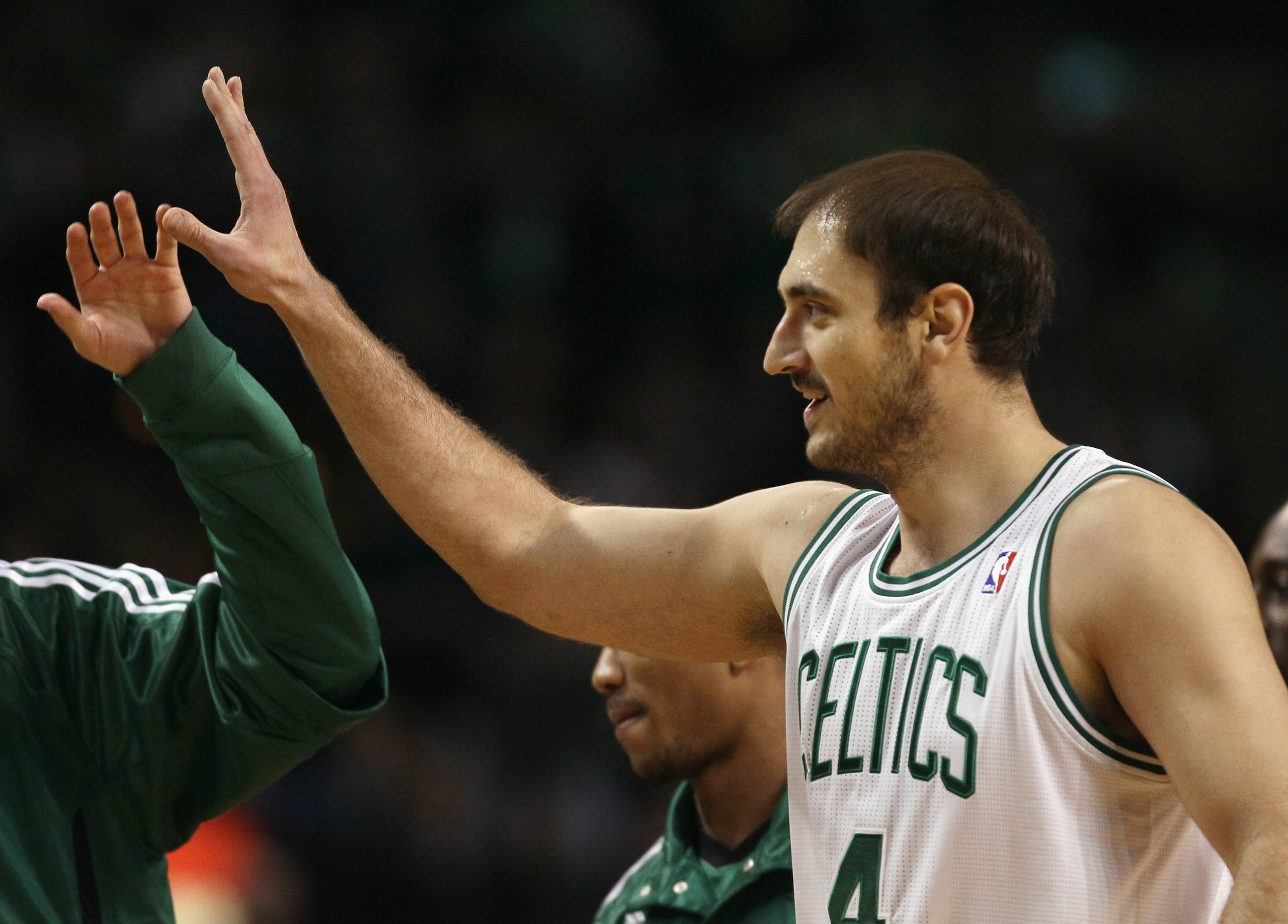 BOSTON, MA - MARCH 02:  Nenad Krstic #4 of the Boston Celtics is congratulated by teammates during a timeout in the first half against the Phoenix Suns on March 2, 2011 at the TD Garden in Boston, Massachusetts.  NOTE TO USER: User expressly acknowledges