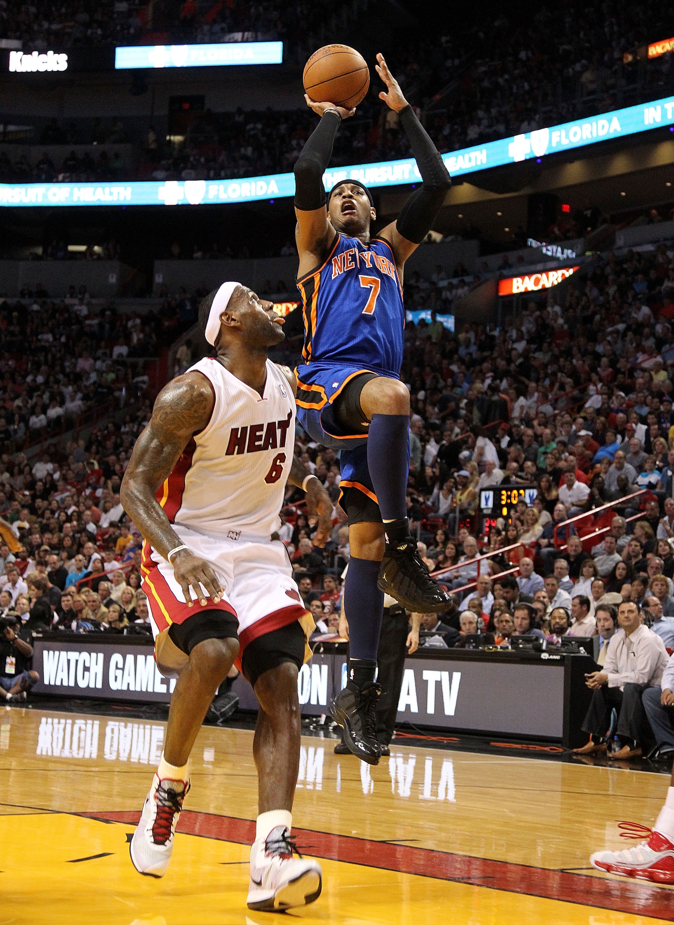 MIAMI, FL - FEBRUARY 27:  Carmelo Anthony #7 of the New York Knicks shoots around LeBron James #6 of the Miami Heat during a game at American Airlines Arena on February 27, 2011 in Miami, Florida. NOTE TO USER: User expressly acknowledges and agrees that,