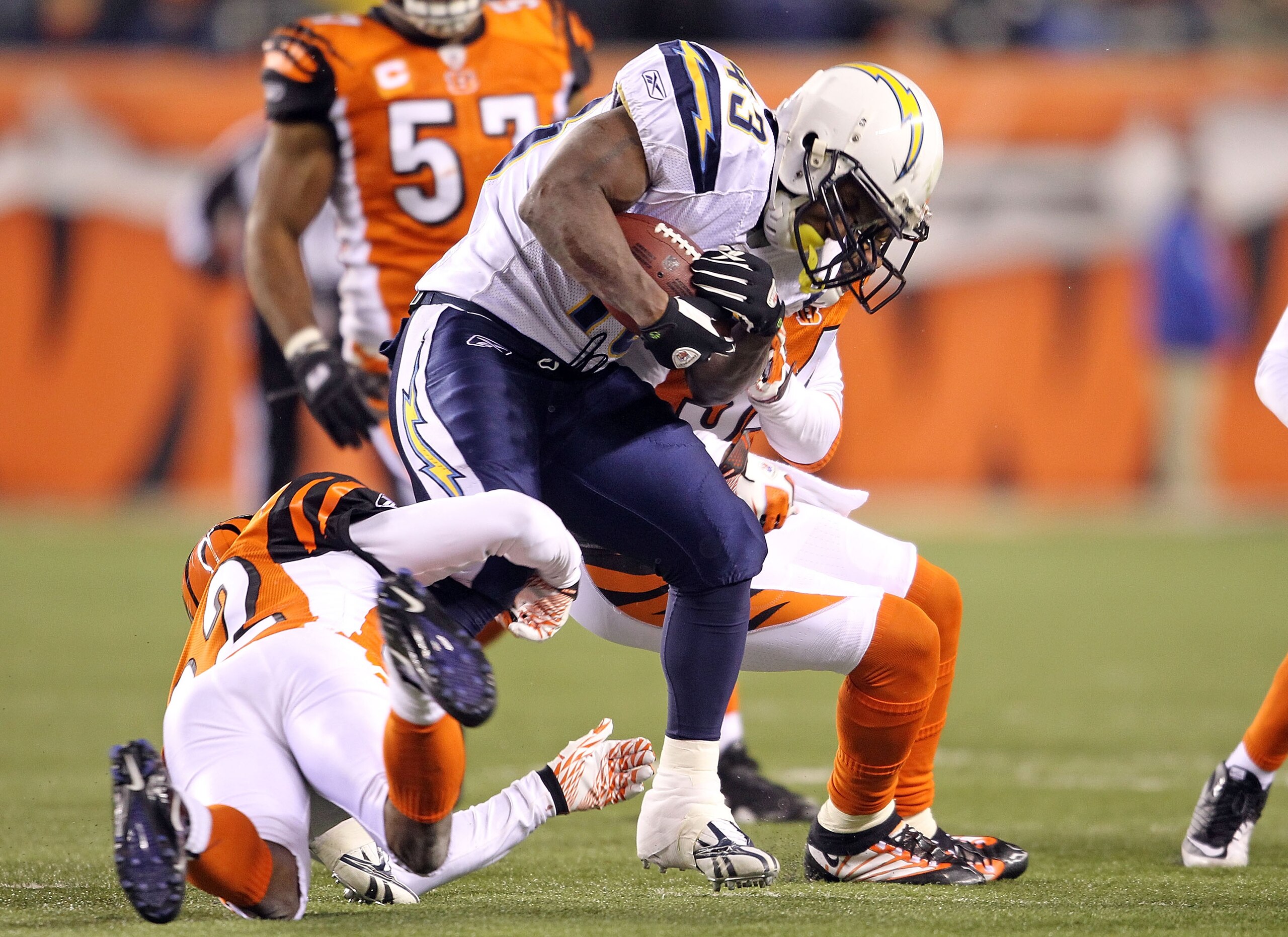 CINCINNATI - DECEMBER 26: Darren Sproles #43 of the San Diego Chargers runs with the ball while tackled by Johnathan Joseph #22 and Keiwan Ratliff #34 of the Cincinnati Bengals in the NFL game at Paul Brown Stadium on December 26, 2010 in Cincinnati, Ohio