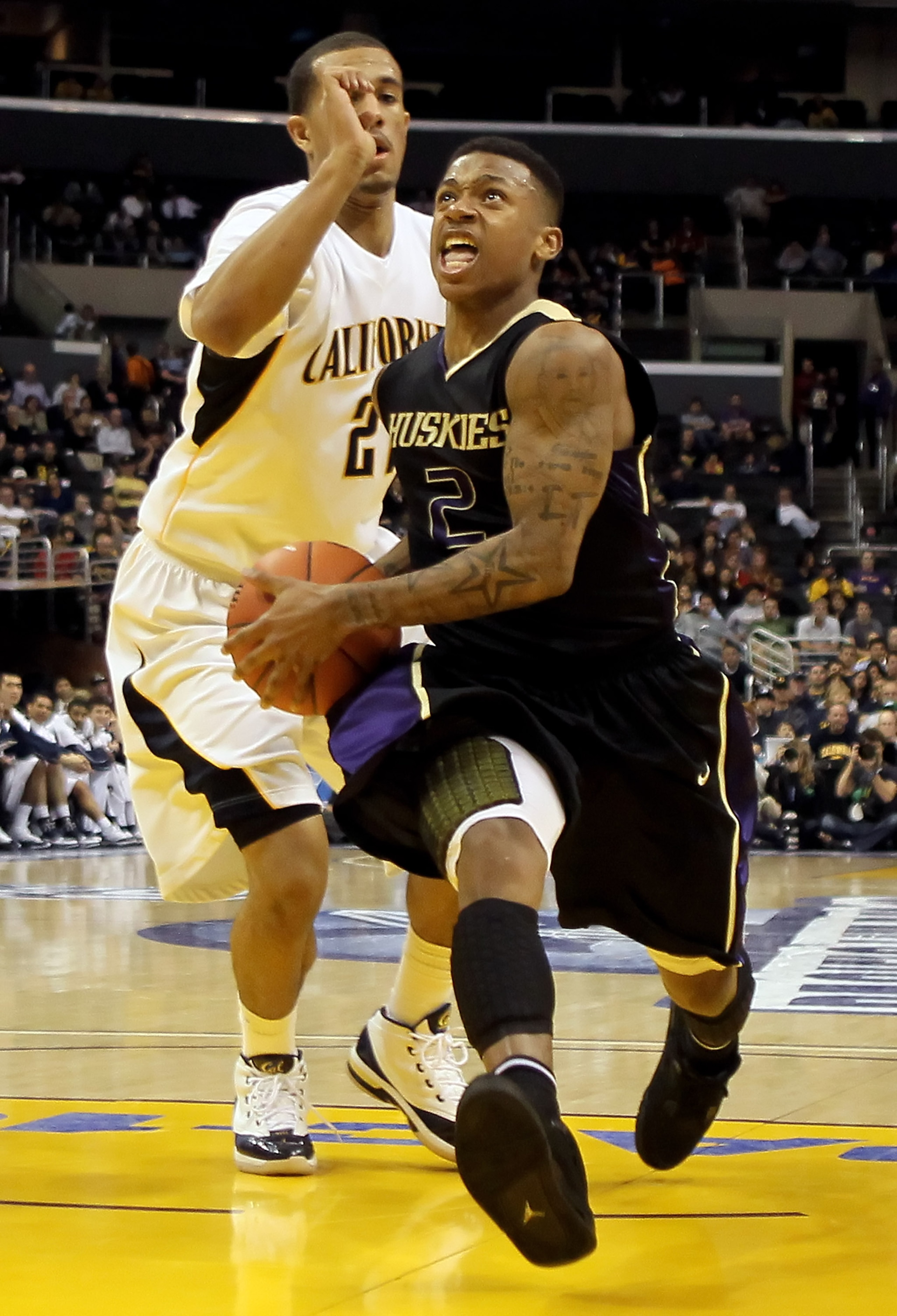 LOS ANGELES, CA - MARCH 13:  Isaiah Thomas #2 of the Washington Huskies drives to the basket past Omondi Amoke #21 of the Cal Golden Bears in the second half during the championship game of the Pac-10 Basketball Tournament at Staples Center on March 13, 2