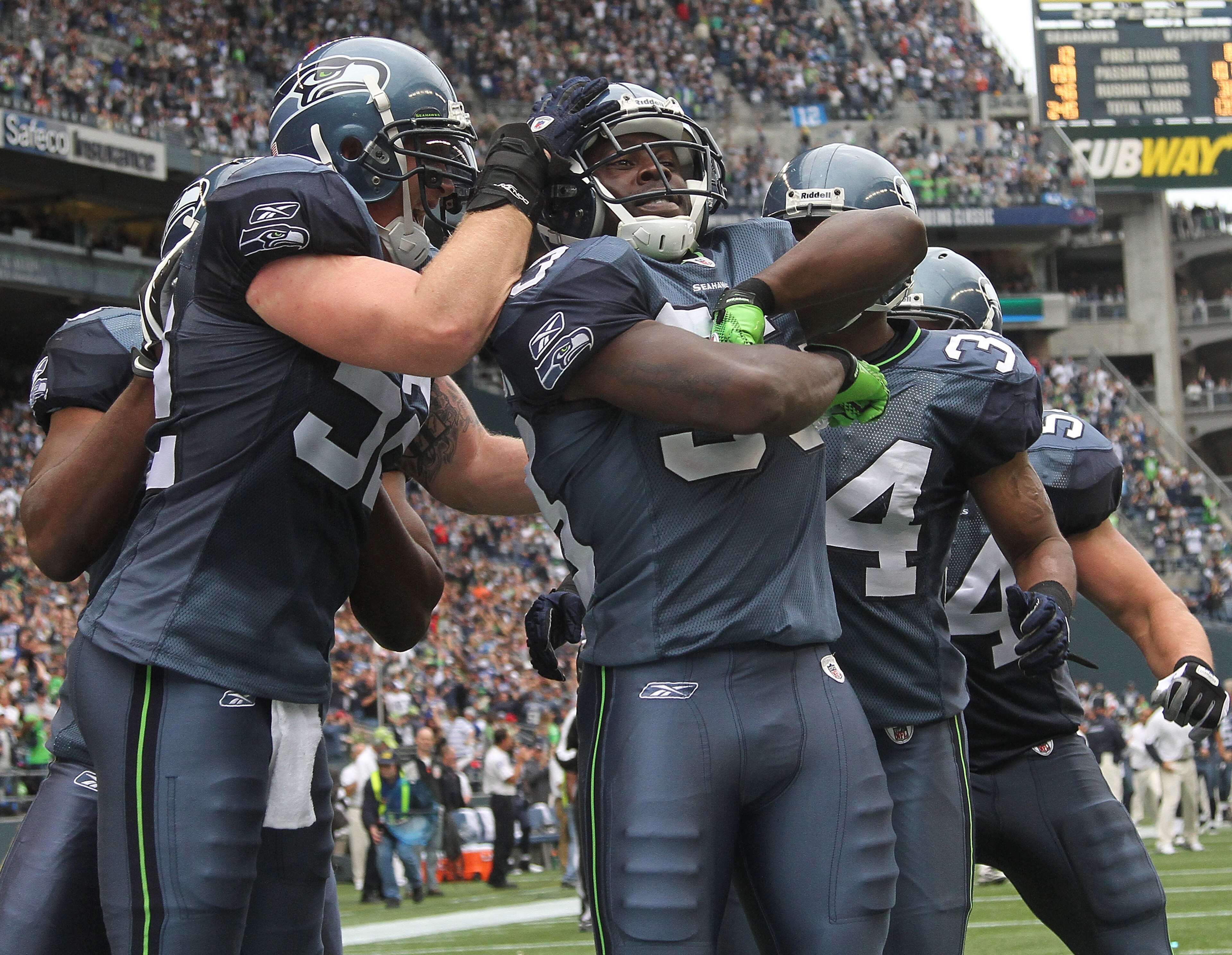 SEATTLE - SEPTEMBER 26:  Kick returner Leon Washington #33 of the Seattle Seahawks (C) celebrates with teammates after scoring a touchdown on a 101 yard kickoff return in the third quarter against the San Diego Chargers at Qwest Field on September 26, 201