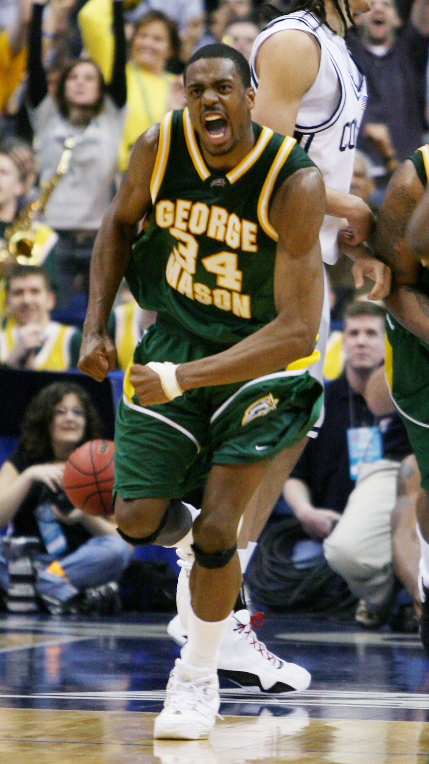 WASHINGTON - MARCH 26: Will Thomas #34 of the George Mason Patriots celebrates late in the second half of their overtime victory over the Connecticut Huskies during the Regional Finals of the NCAA Men's Basketball Tournament on March 26, 2006 at the Veriz